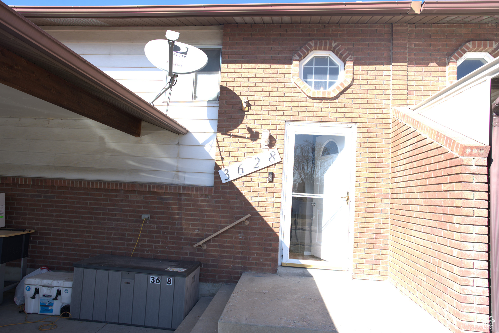 View of exterior entry featuring brick siding