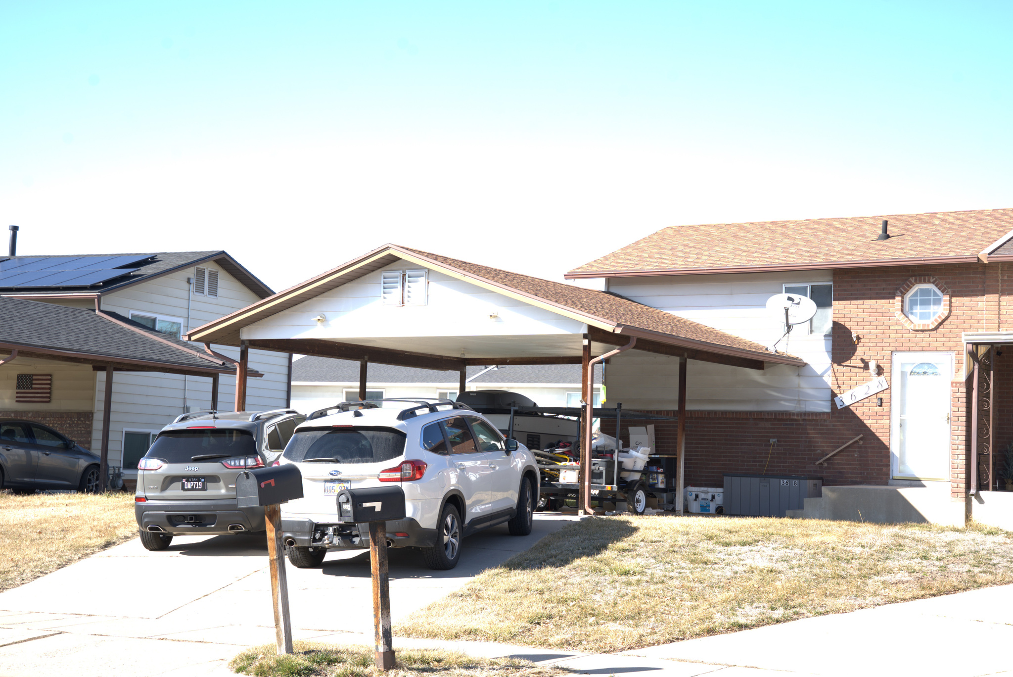 View of parking featuring a carport and concrete driveway