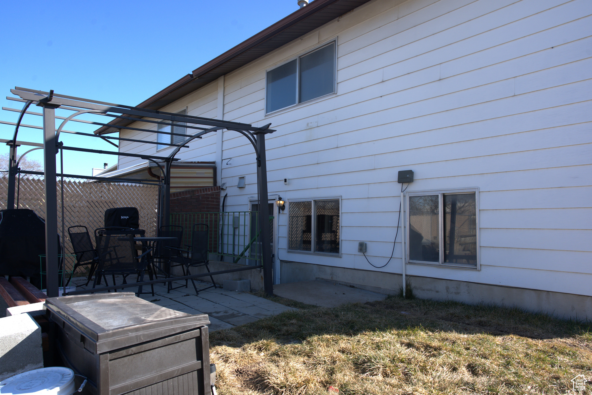 View of home's exterior with a patio and fence