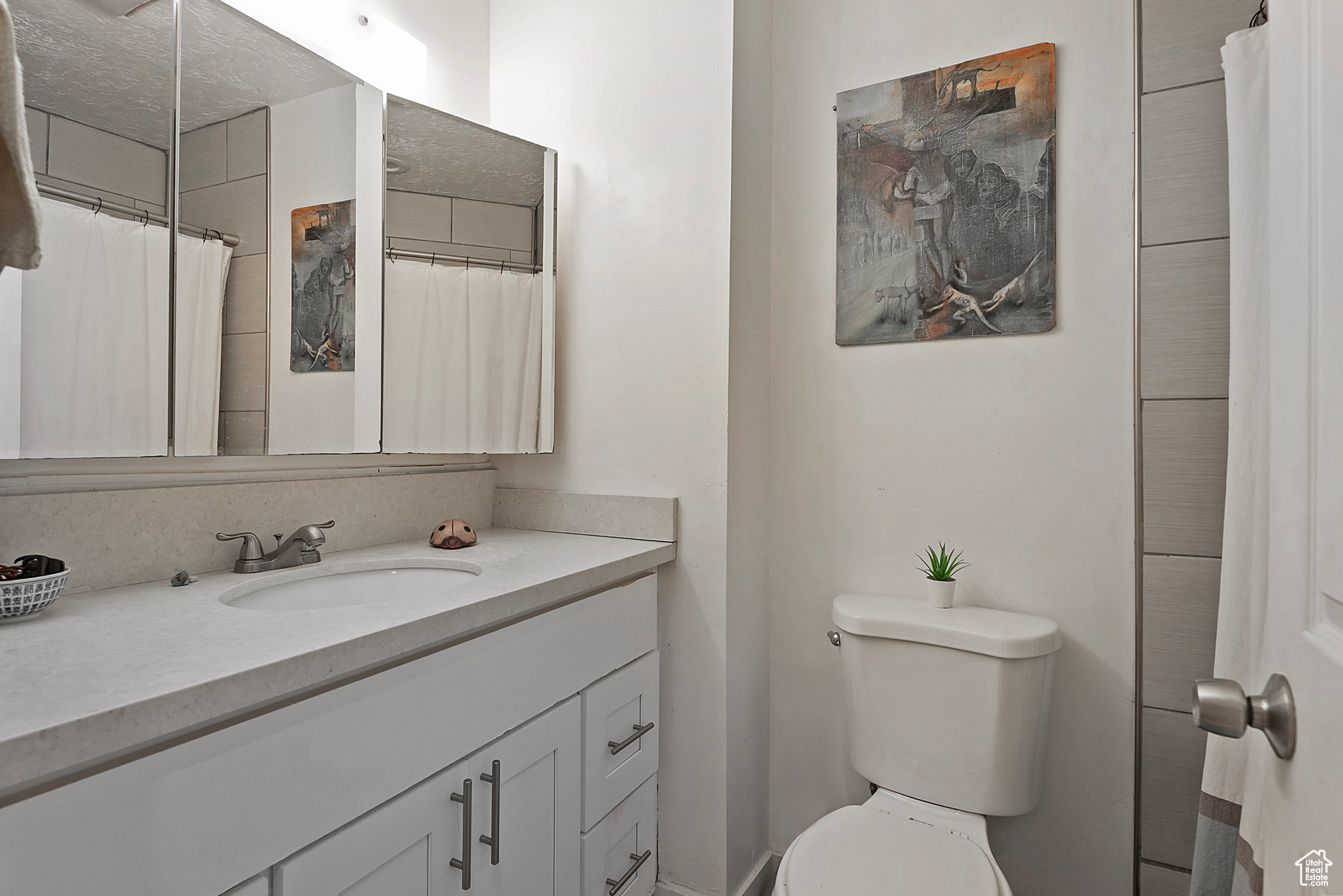 Full bath featuring toilet and vanity