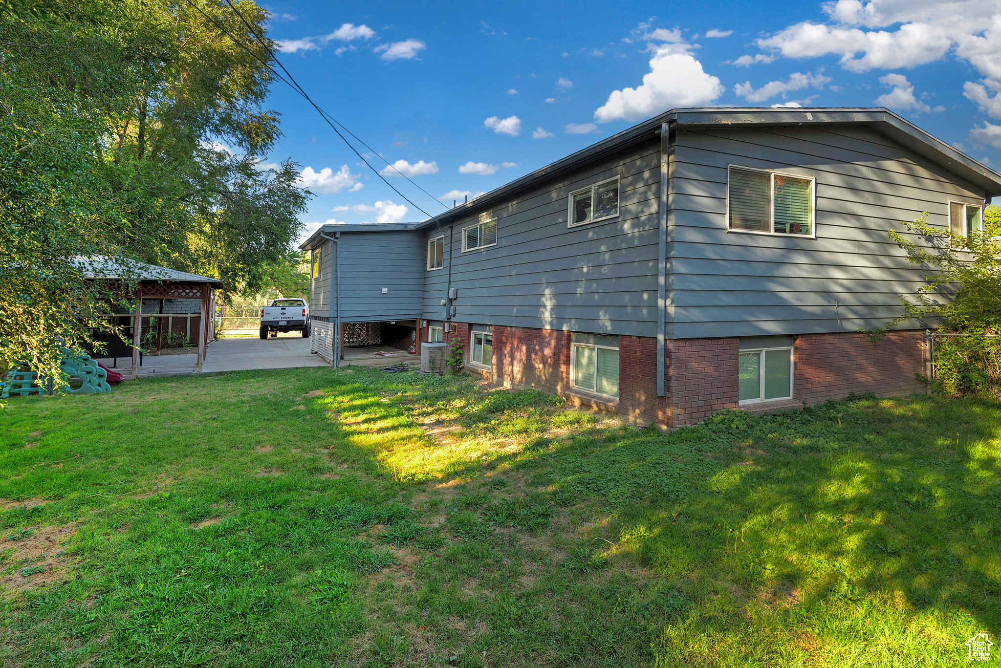 Back of house featuring a lawn