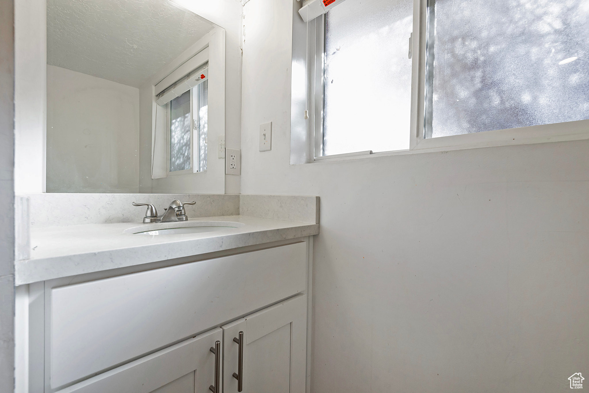 Bathroom featuring vanity and a healthy amount of sunlight