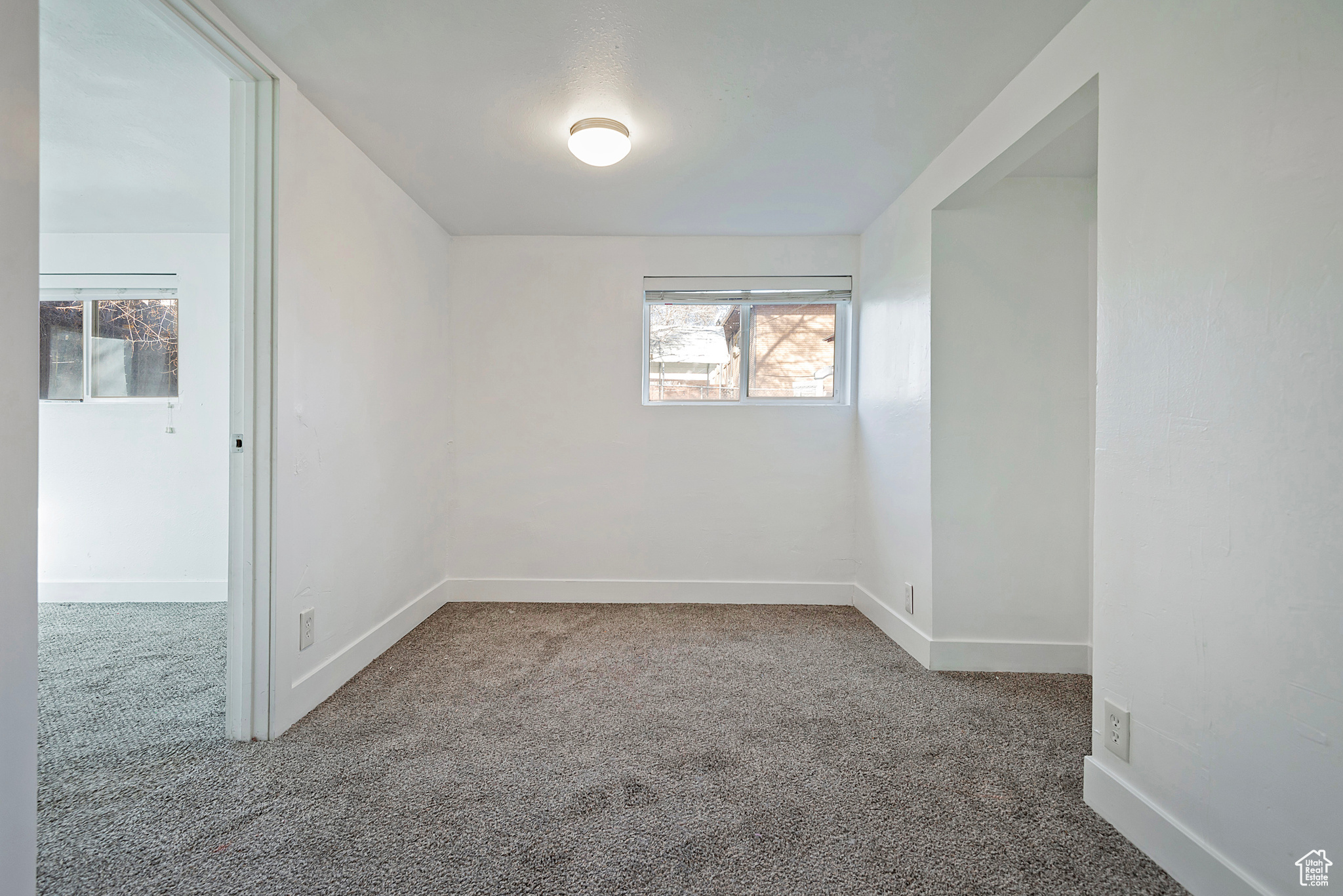 Carpeted spare room with baseboards