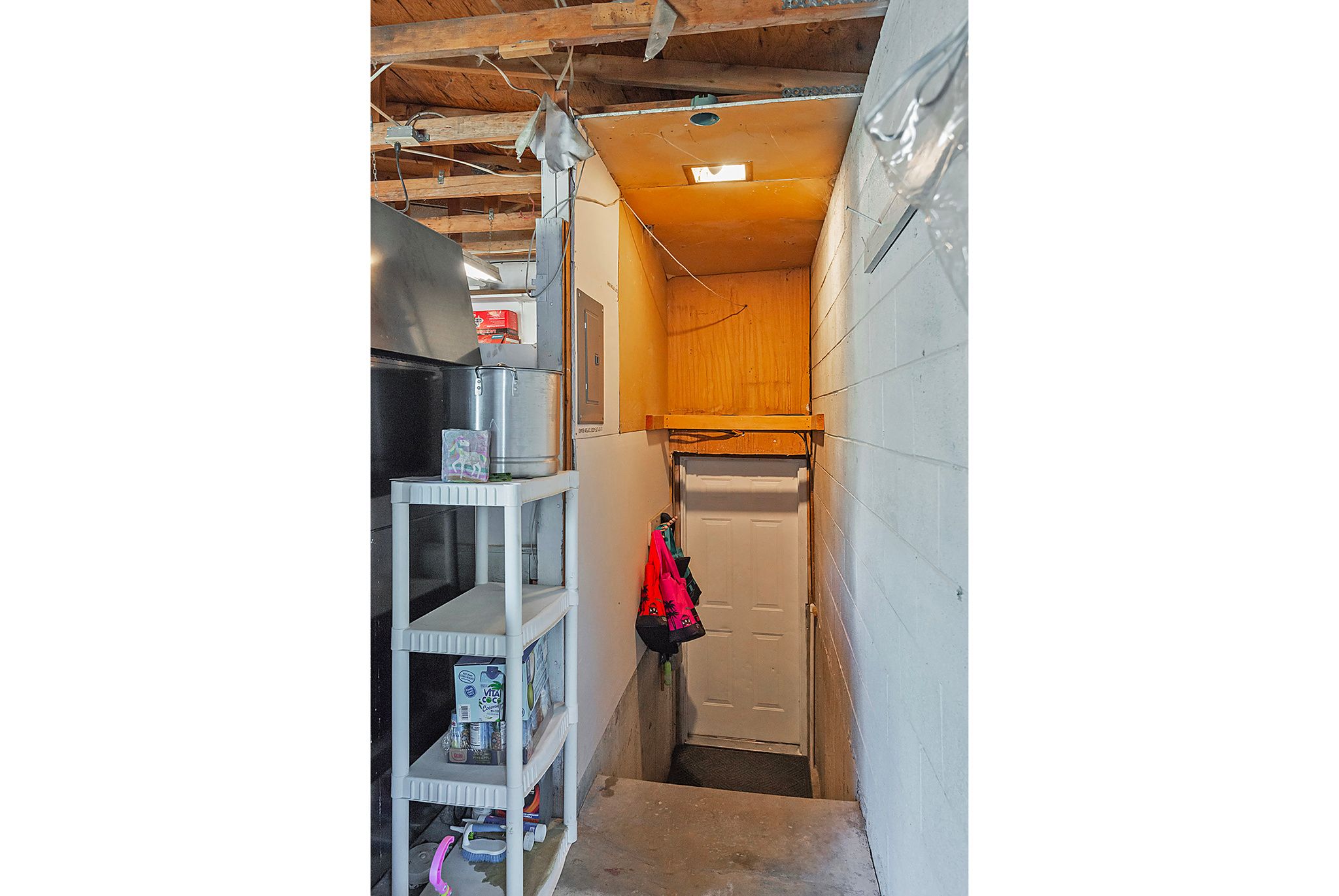 Interior space featuring concrete flooring and concrete block wall