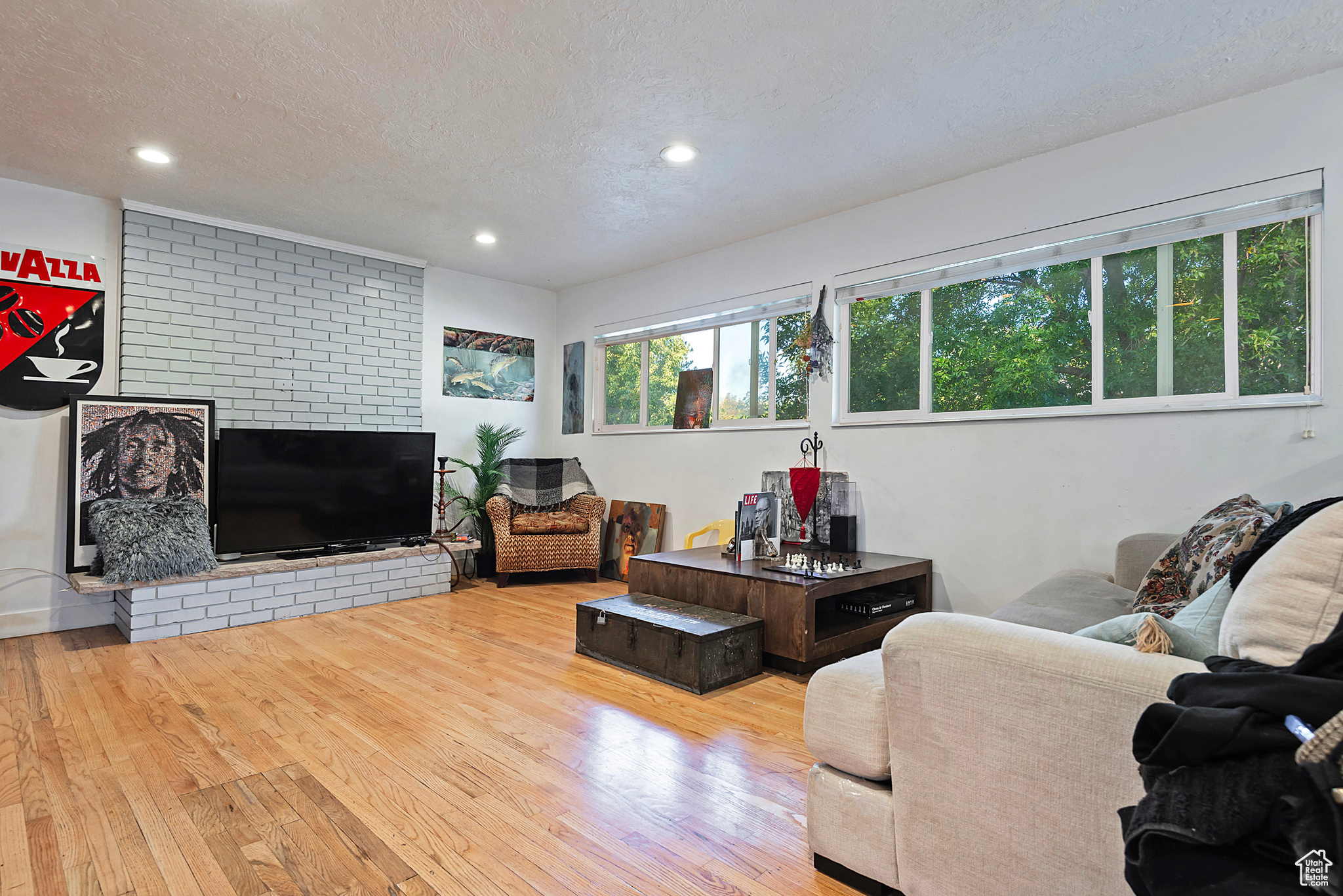 Living room with recessed lighting, a textured ceiling, and hardwood / wood-style flooring