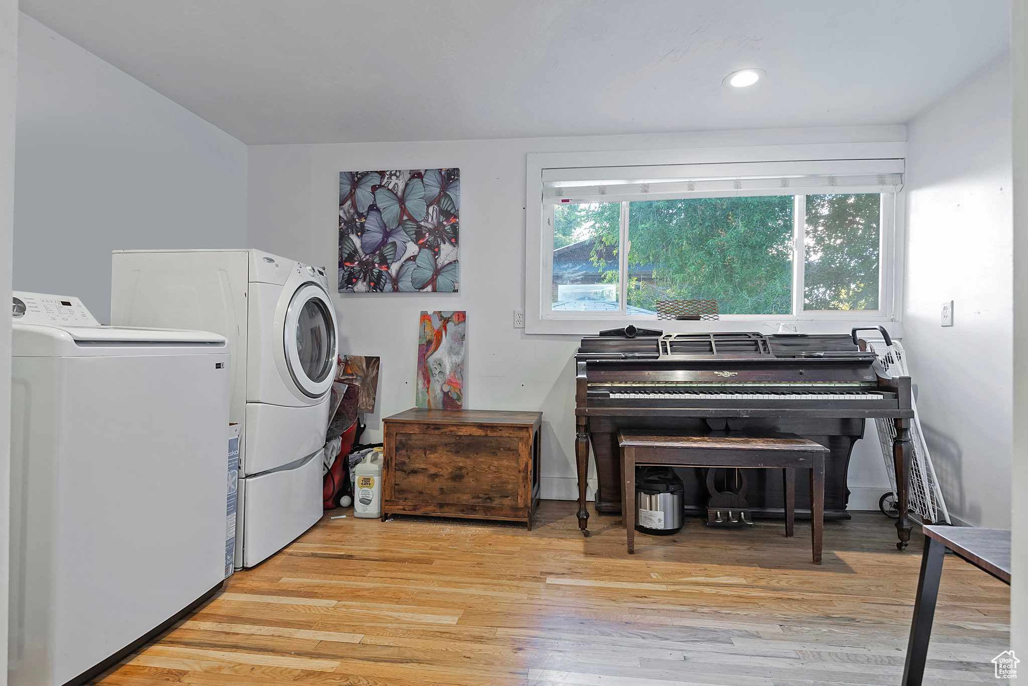 Washroom featuring recessed lighting, washing machine and dryer, and wood finished floors