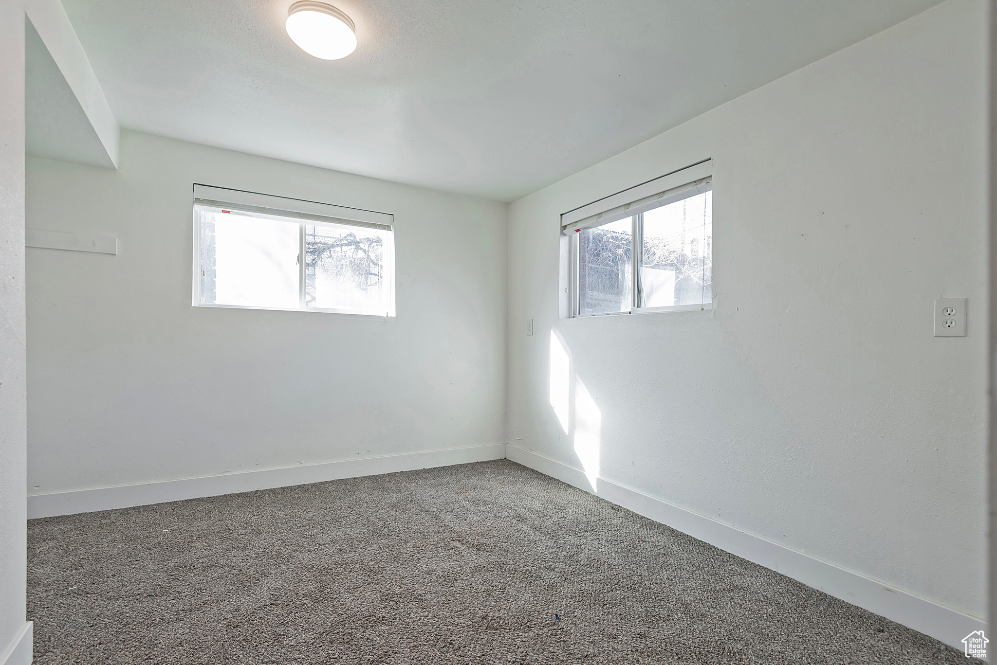 Empty room with baseboards and carpet floors