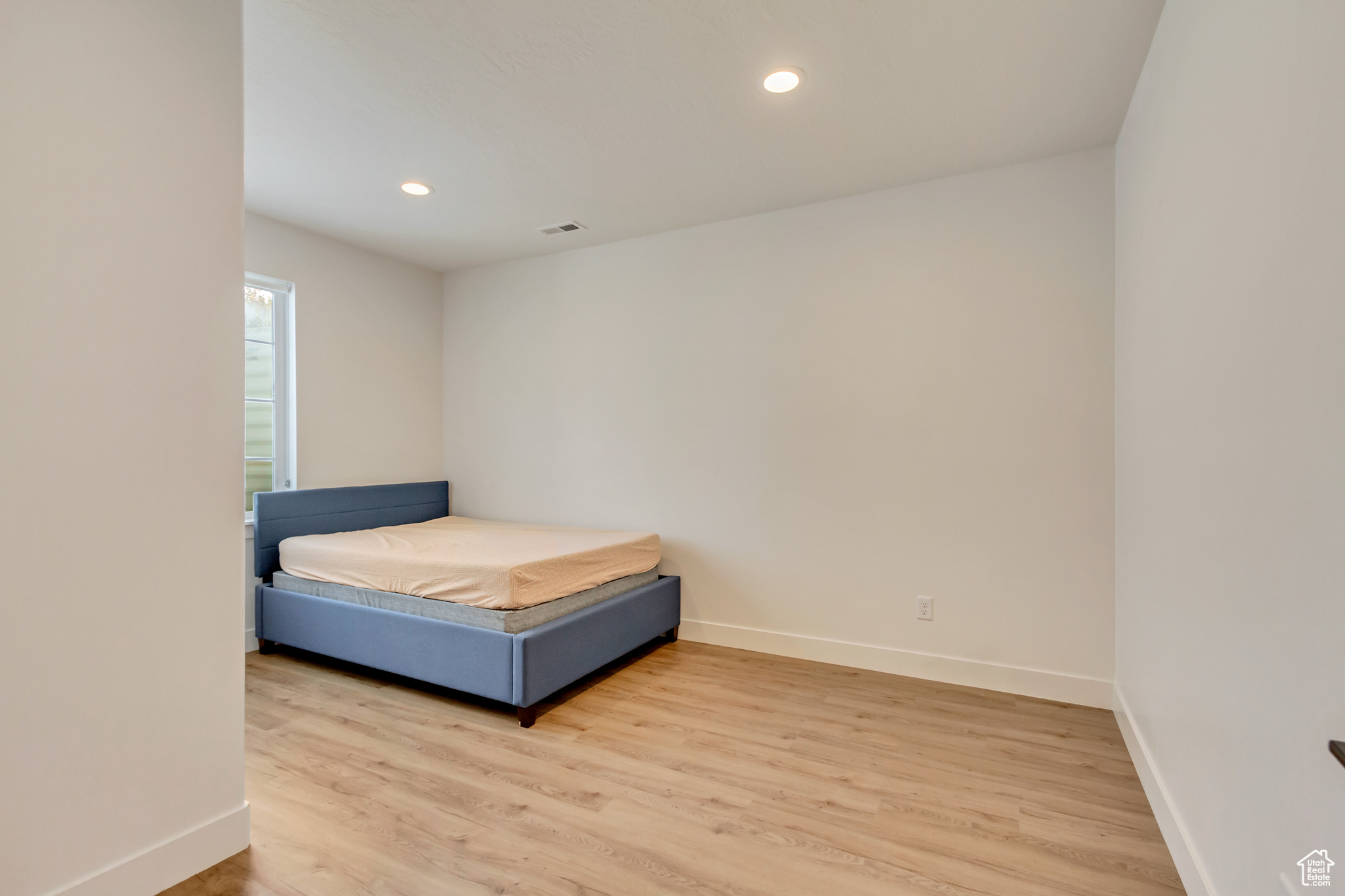 Unfurnished bedroom with visible vents, recessed lighting, baseboards, and light wood-style floors