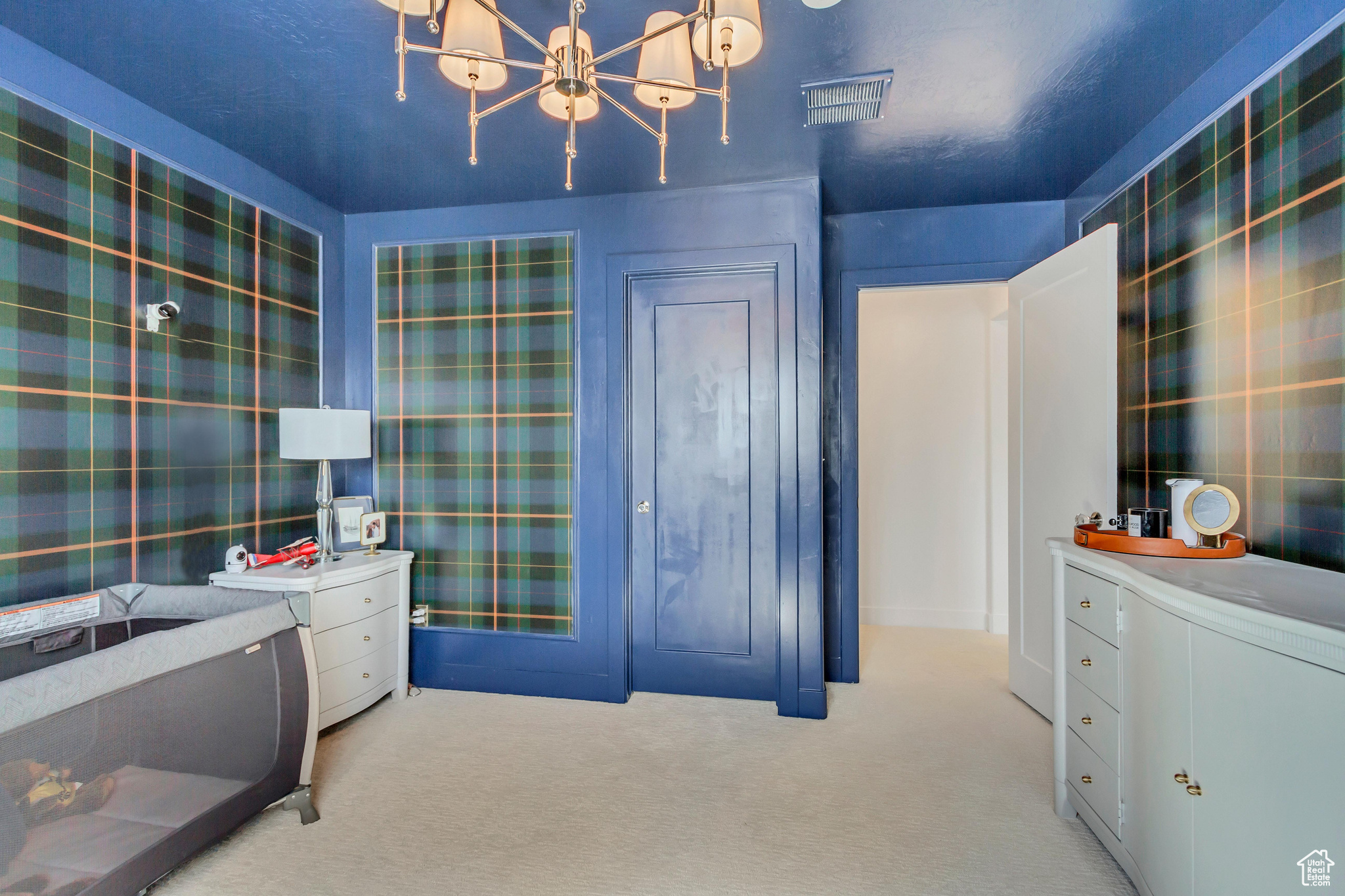 Bedroom featuring an inviting chandelier, visible vents, and carpet floors