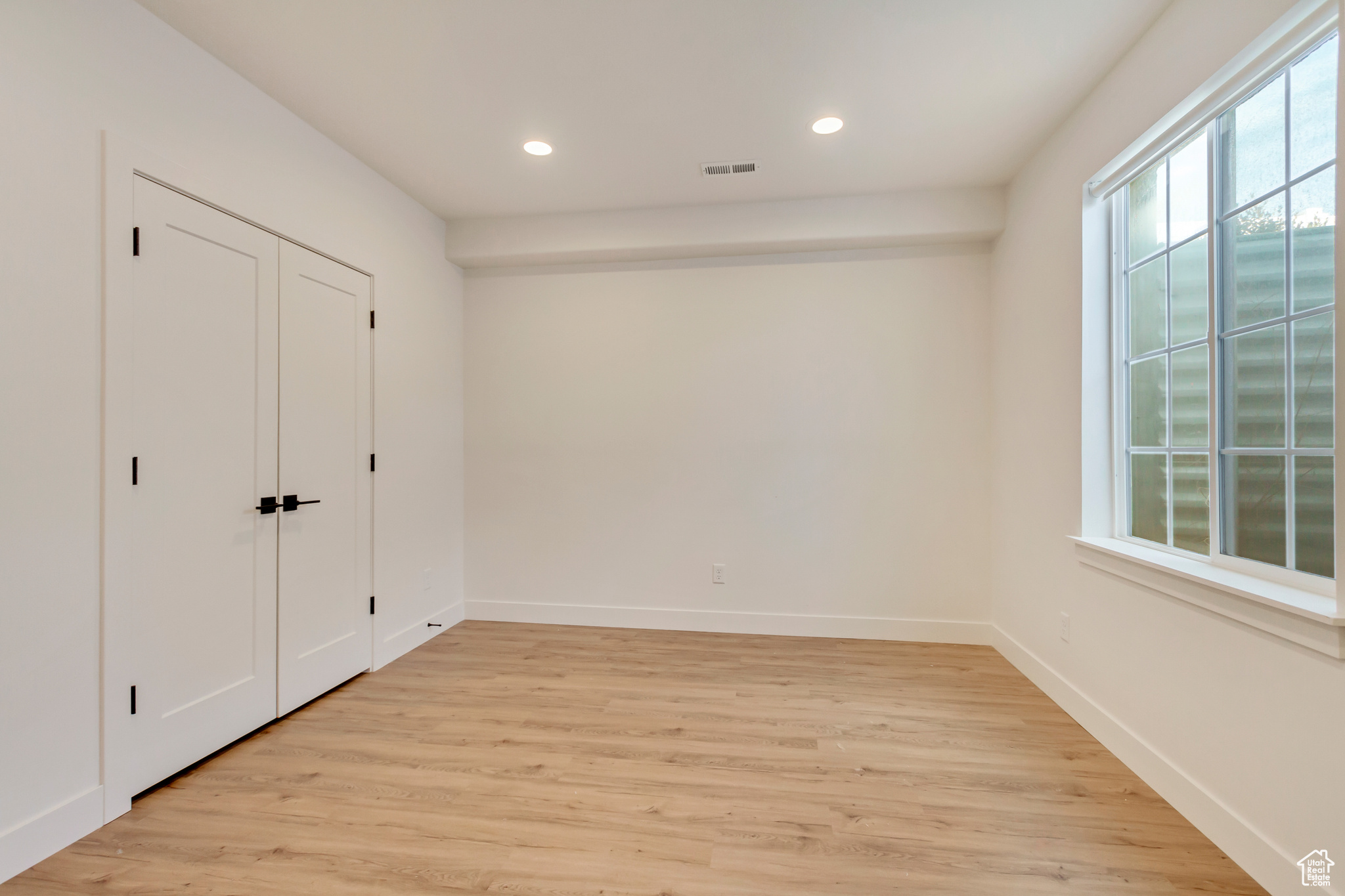 Unfurnished bedroom with recessed lighting, visible vents, baseboards, and light wood finished floors