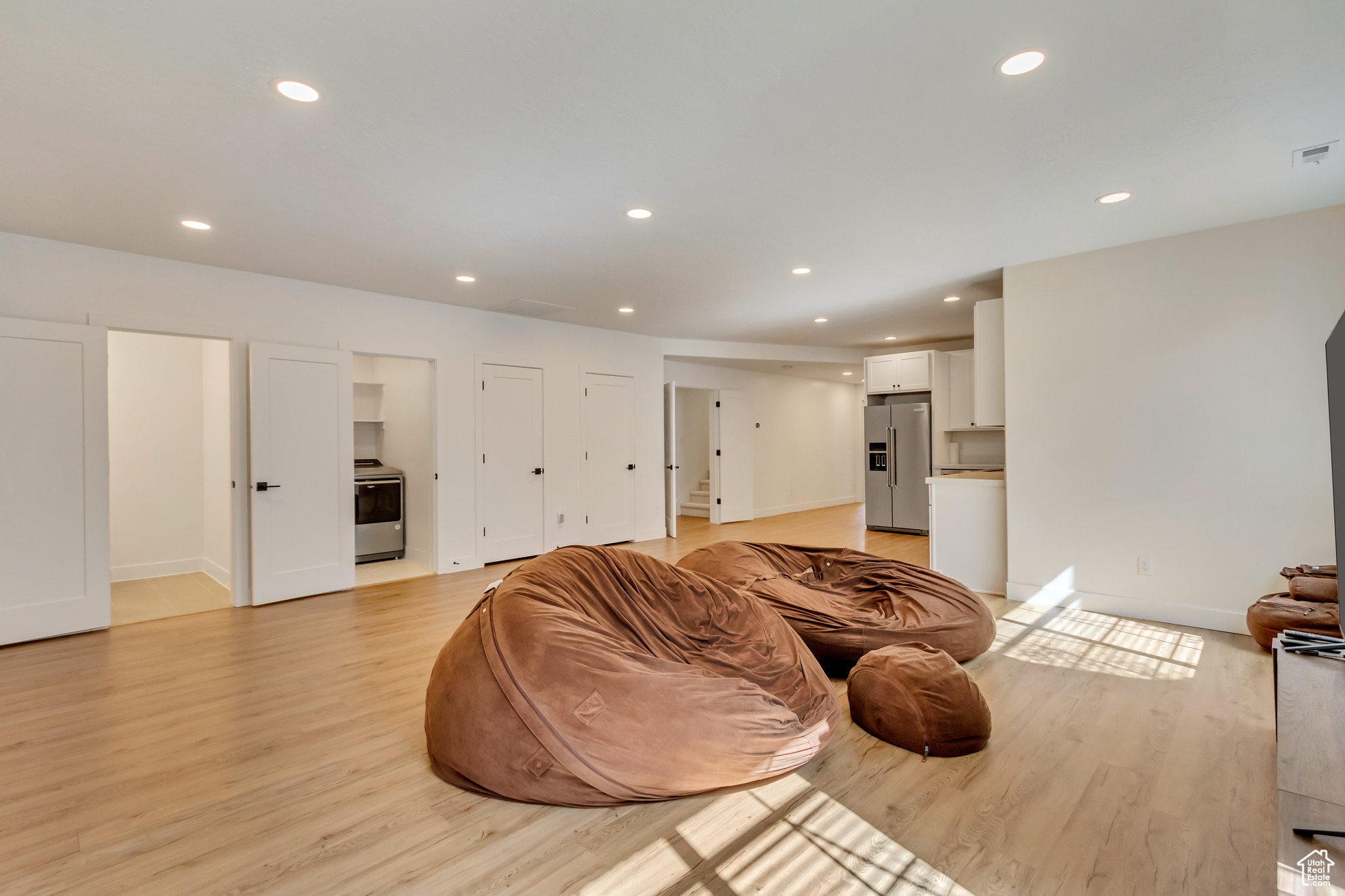 Living area with recessed lighting, baseboards, and light wood finished floors