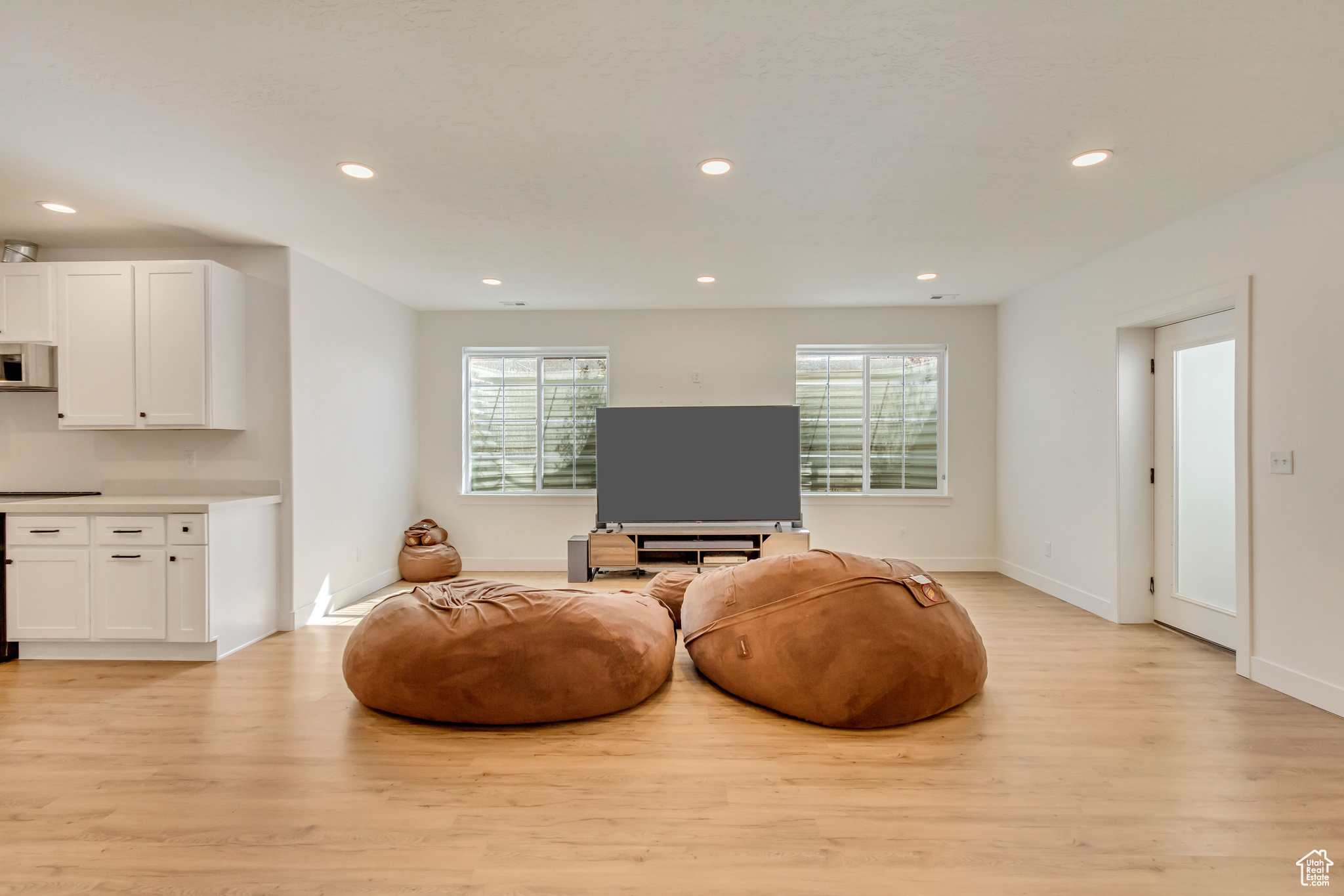 Sitting room with recessed lighting, light wood-type flooring, and baseboards