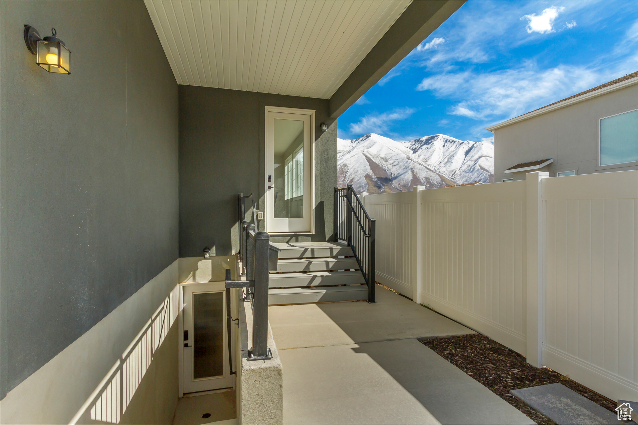 View of patio featuring a mountain view and fence