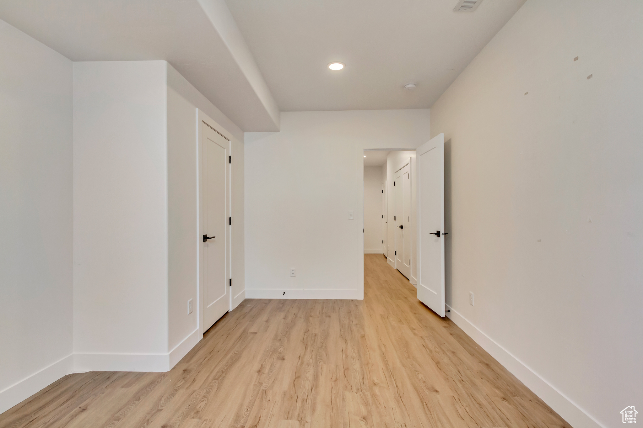 Spare room with recessed lighting, baseboards, and light wood-style flooring