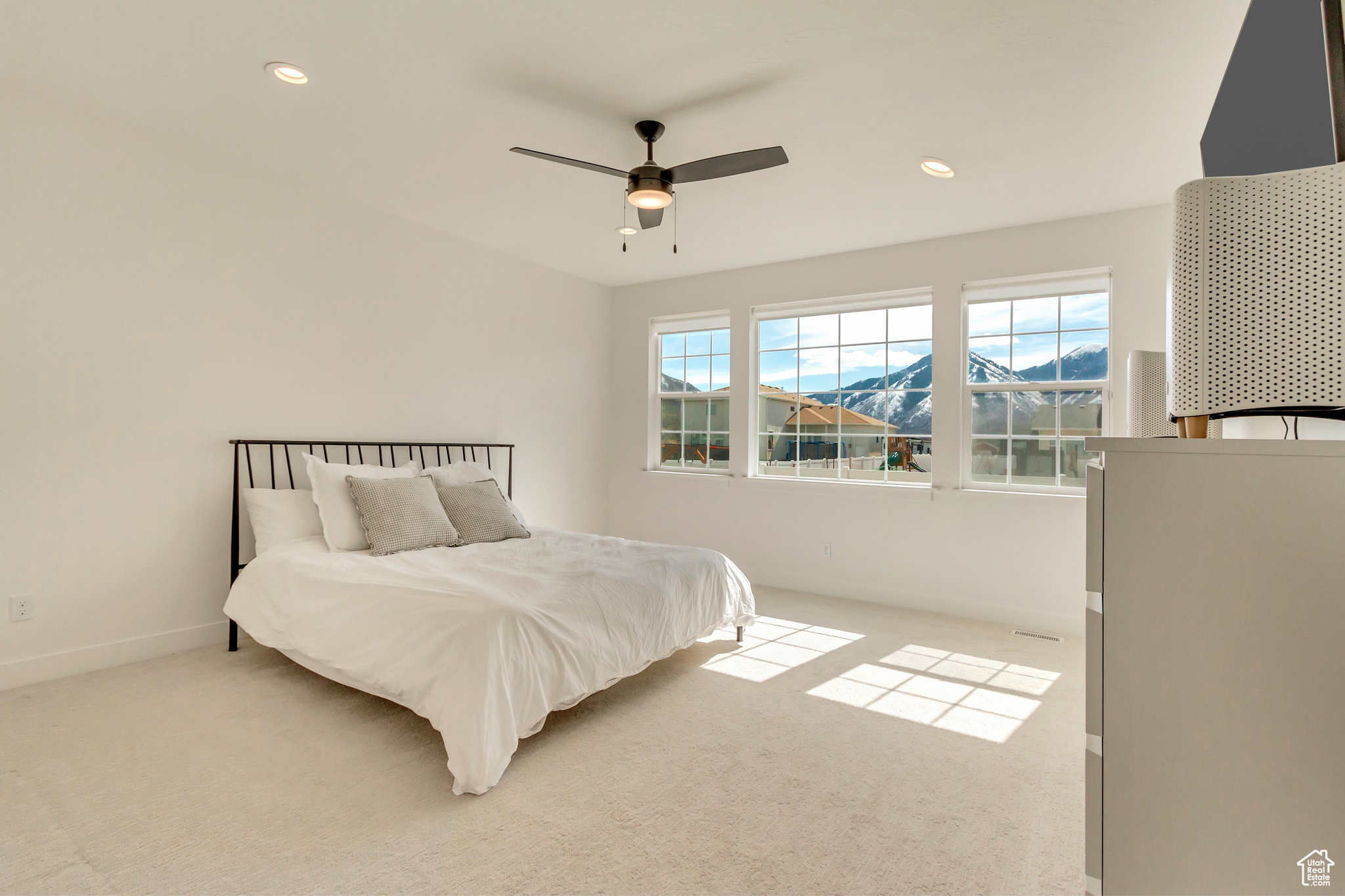 Bedroom with light carpet, recessed lighting, baseboards, and ceiling fan