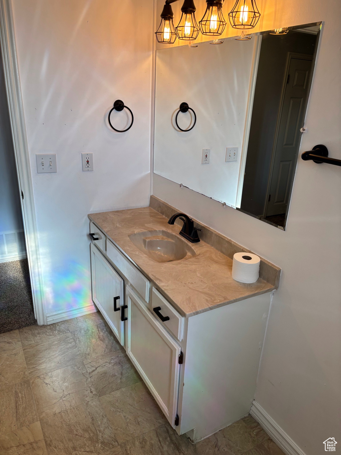 Bathroom featuring baseboards and vanity