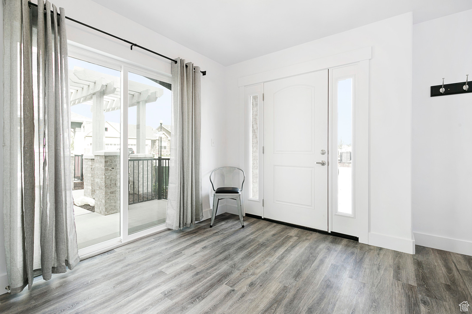 Entrance foyer featuring baseboards and wood finished floors