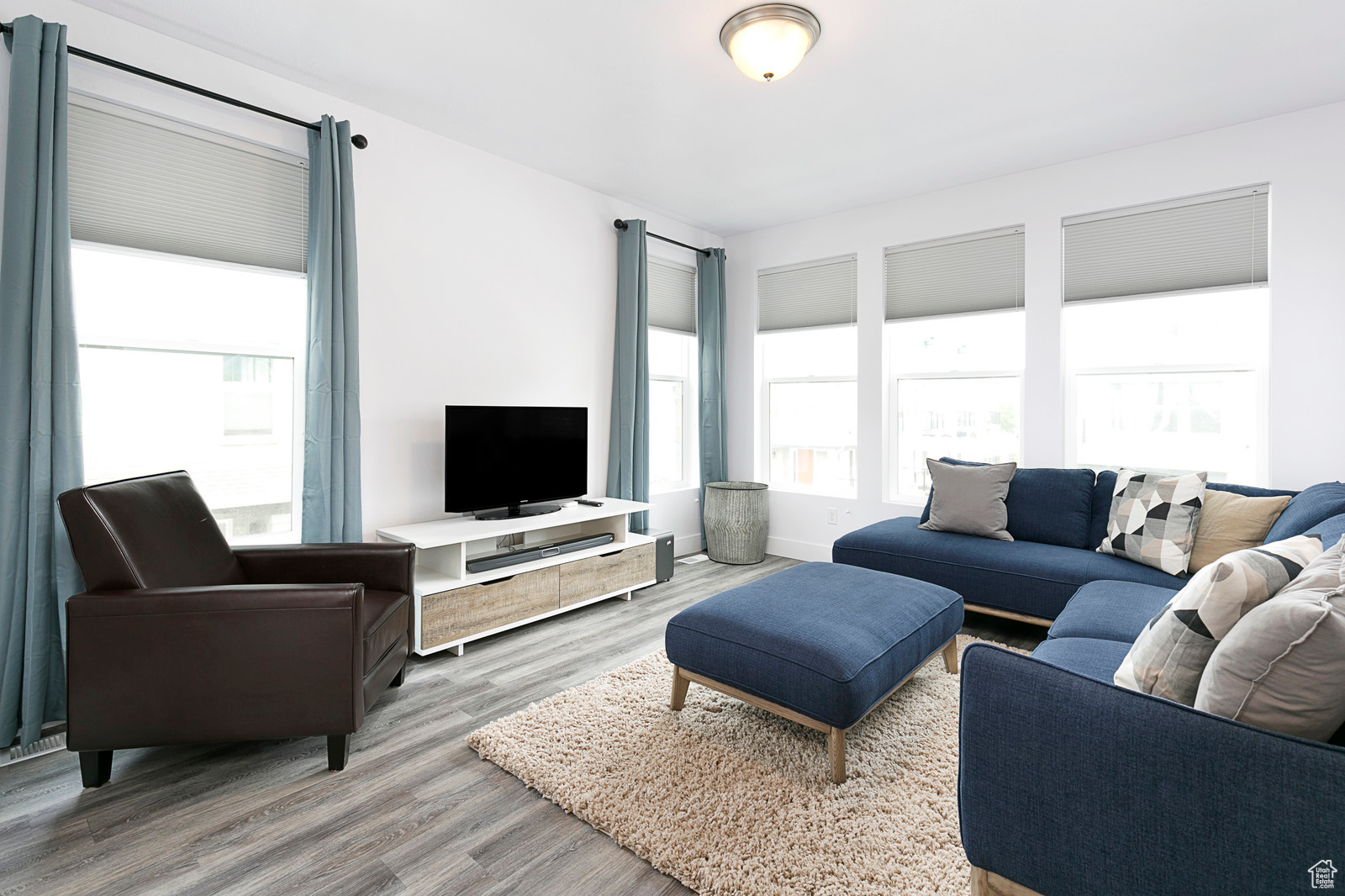 Living area with wood finished floors and baseboards