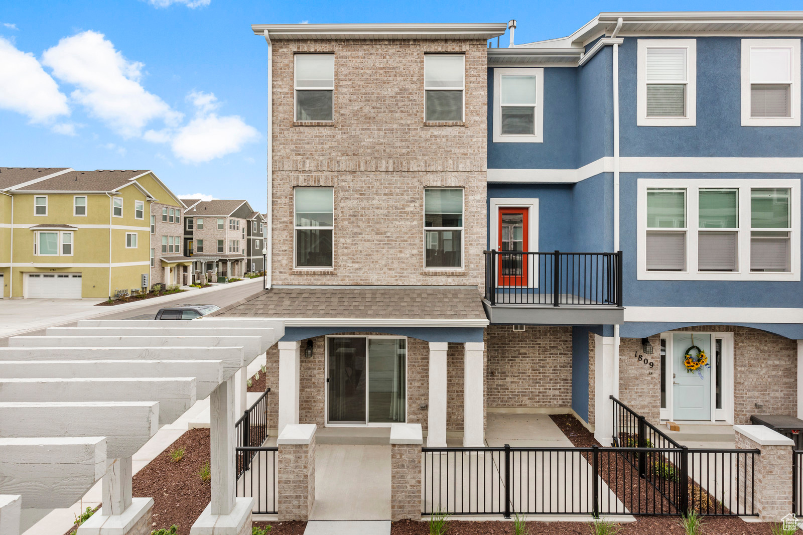 View of front of house featuring brick siding and stucco siding