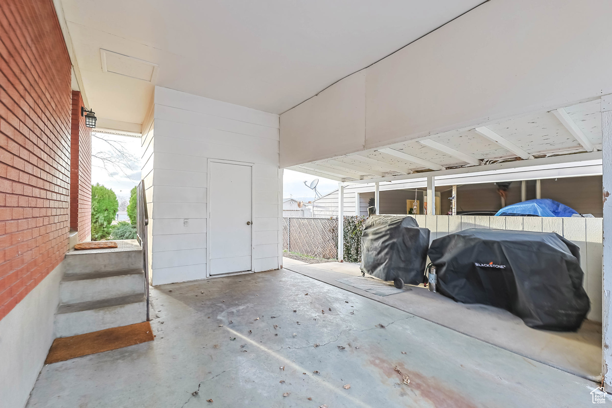 Garage featuring an attached carport