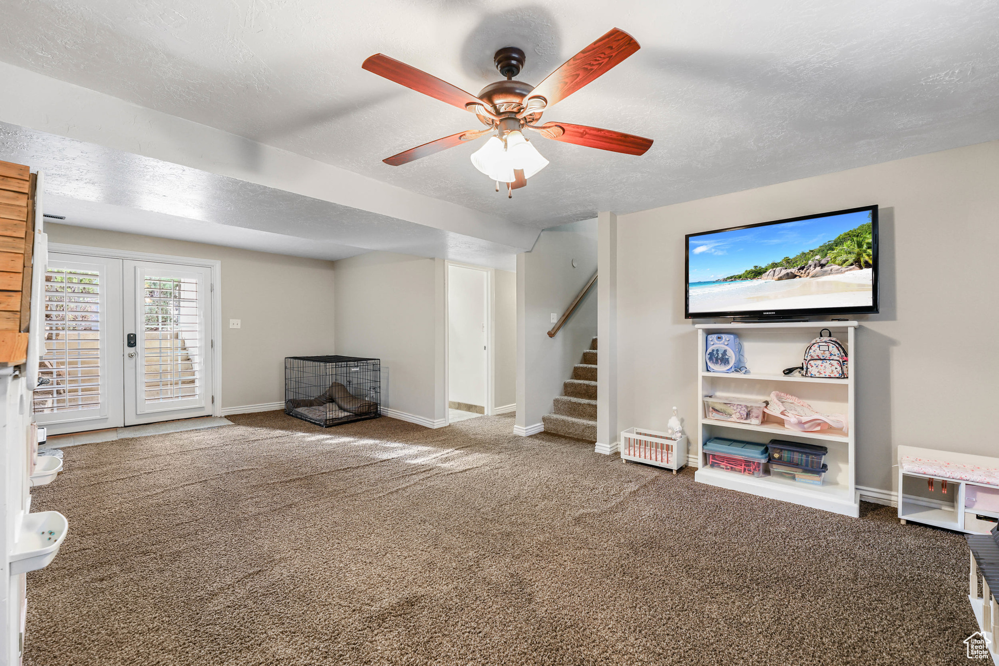 Interior space with baseboards, carpet, stairs, french doors, and a textured ceiling