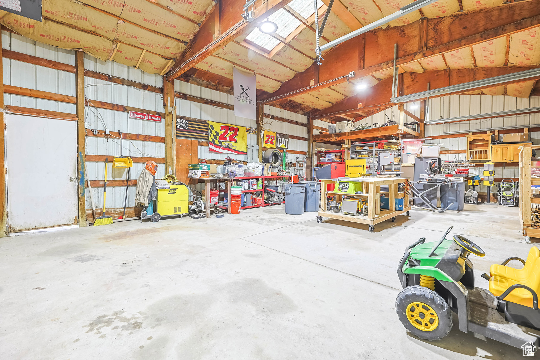 Garage featuring a workshop area and metal wall