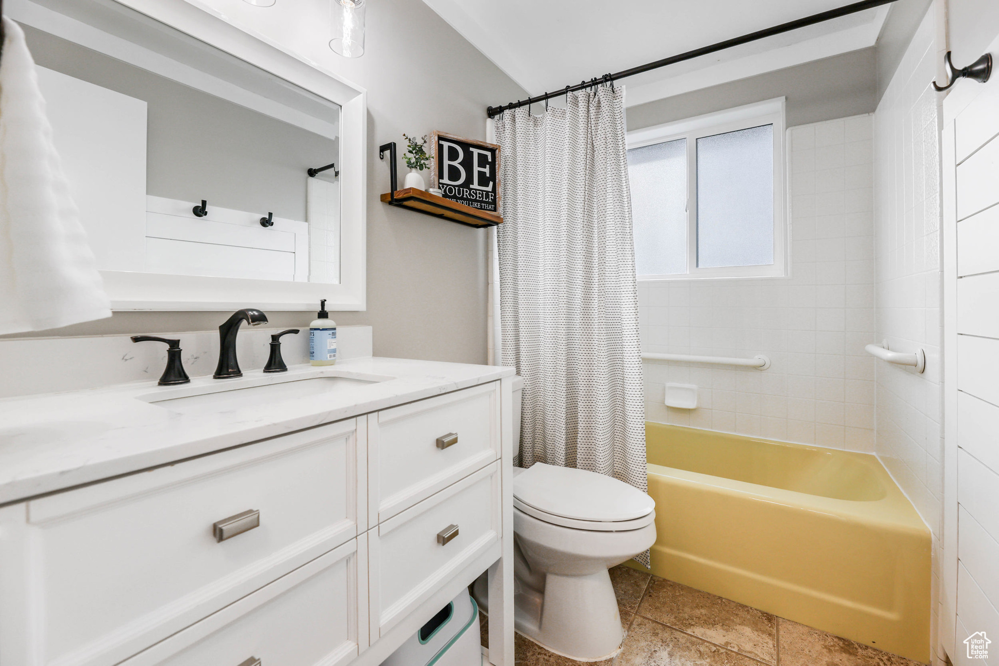 Bathroom with shower / tub combo, toilet, and vanity