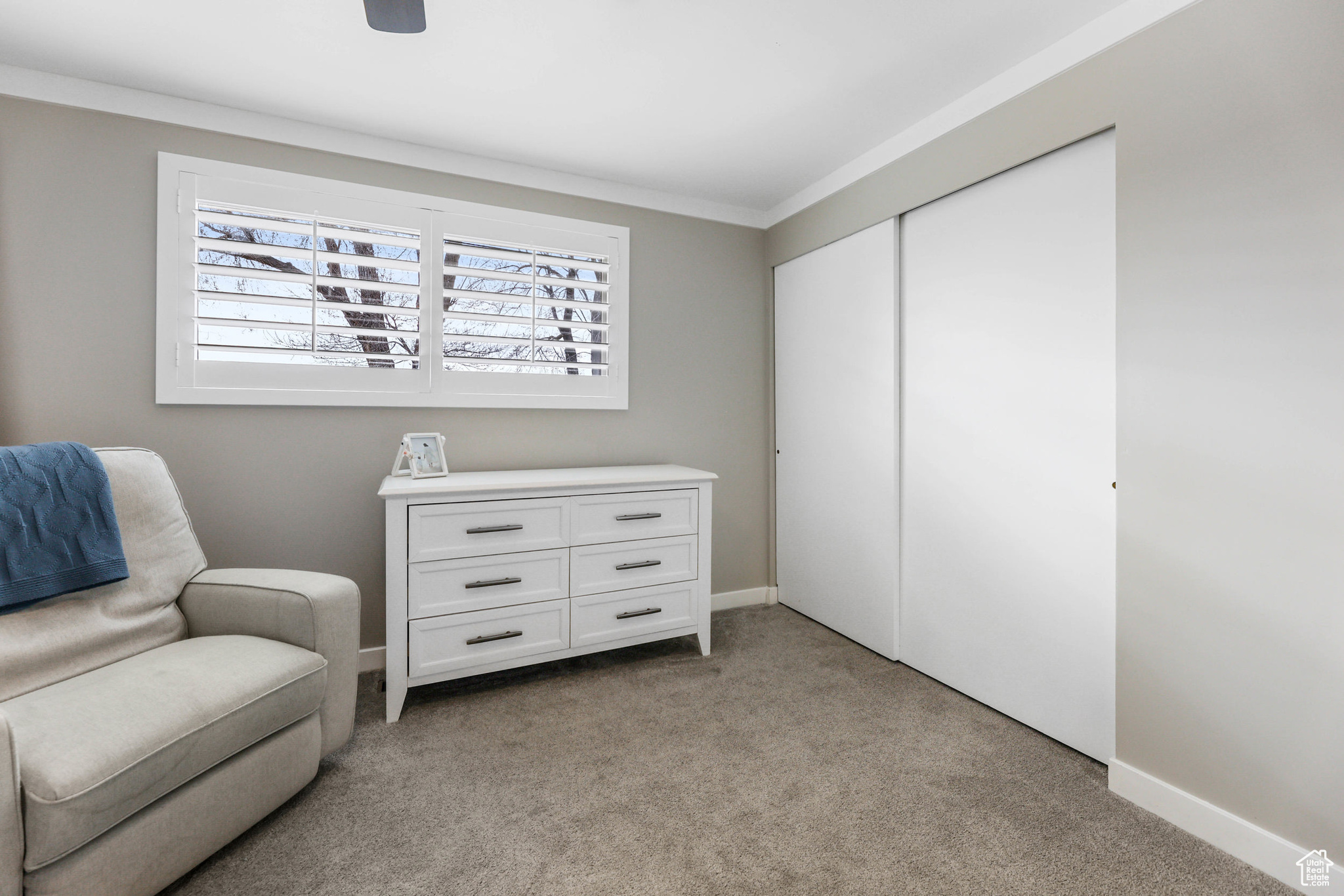 Sitting room with light carpet, baseboards, and ornamental molding