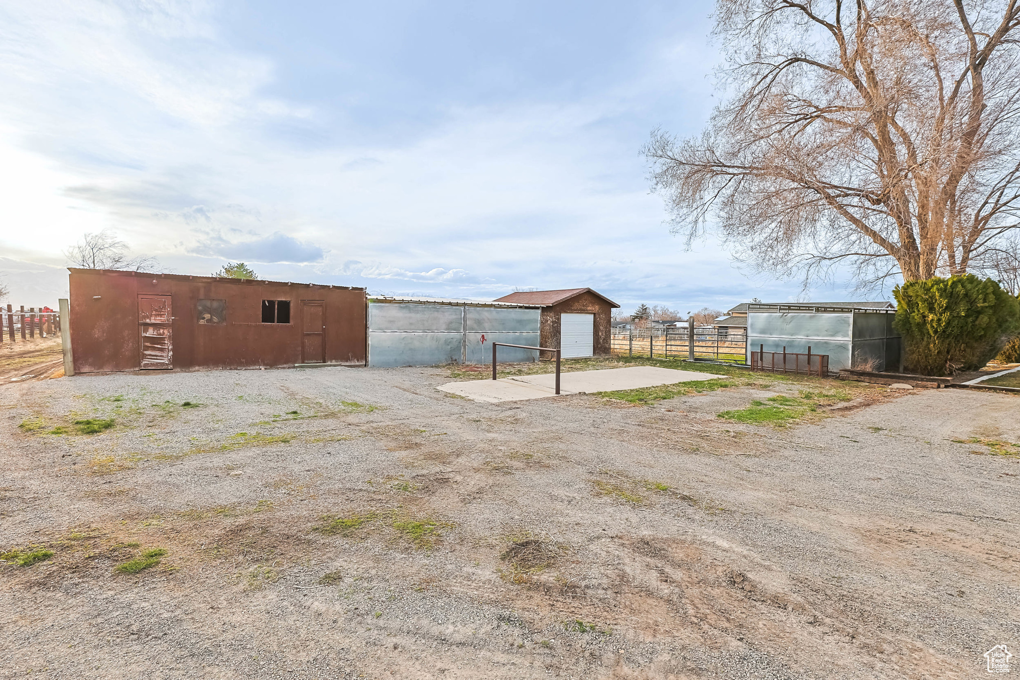 View of yard featuring an outbuilding and fence