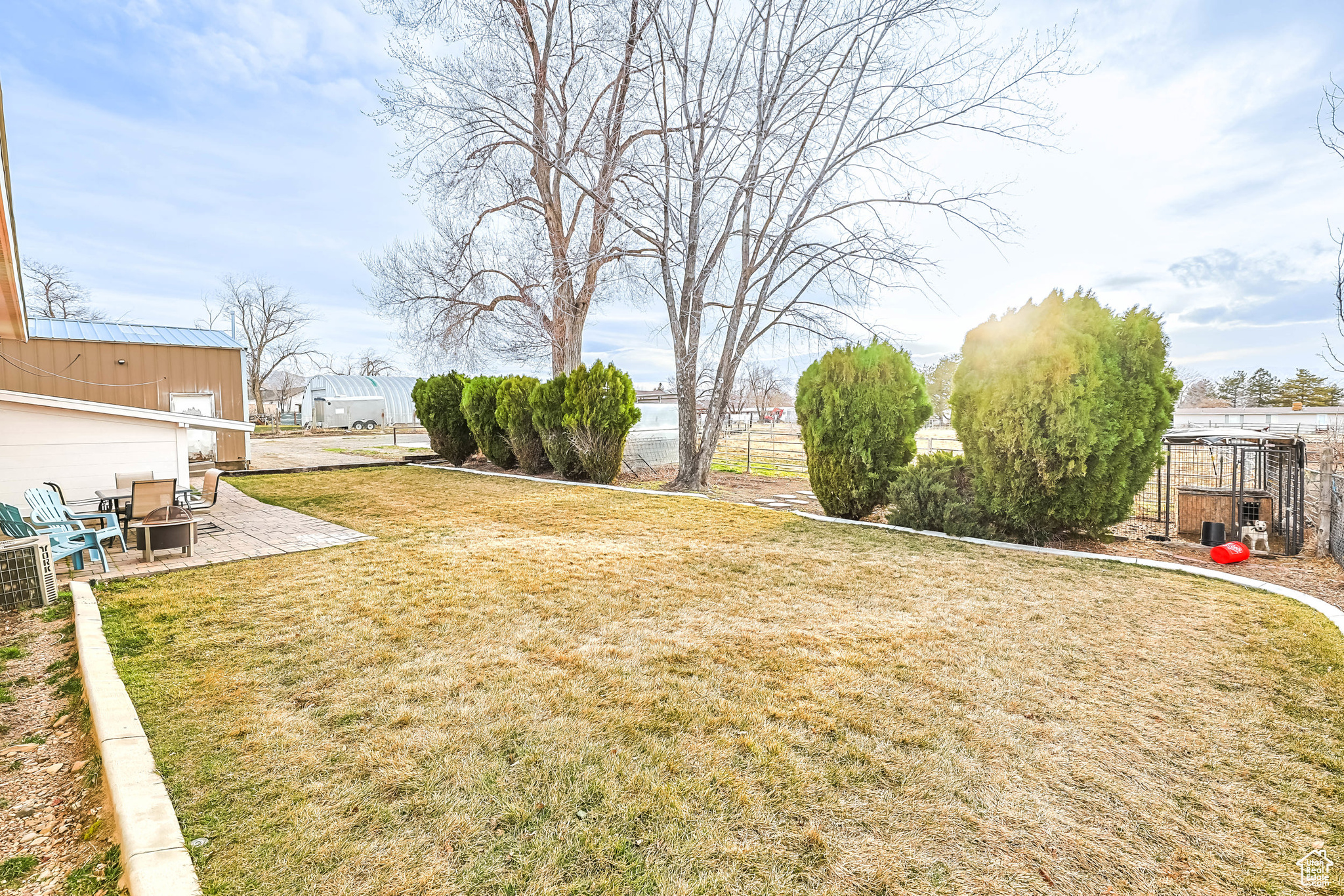 View of yard with a patio area, an outdoor fire pit, and fence