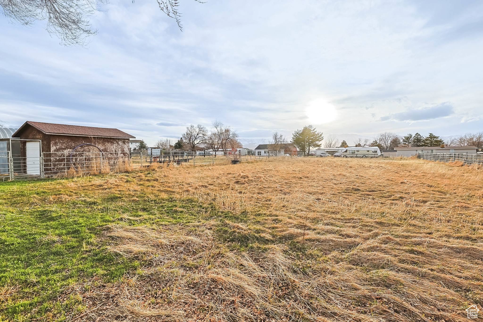 View of yard featuring an outdoor structure and fence