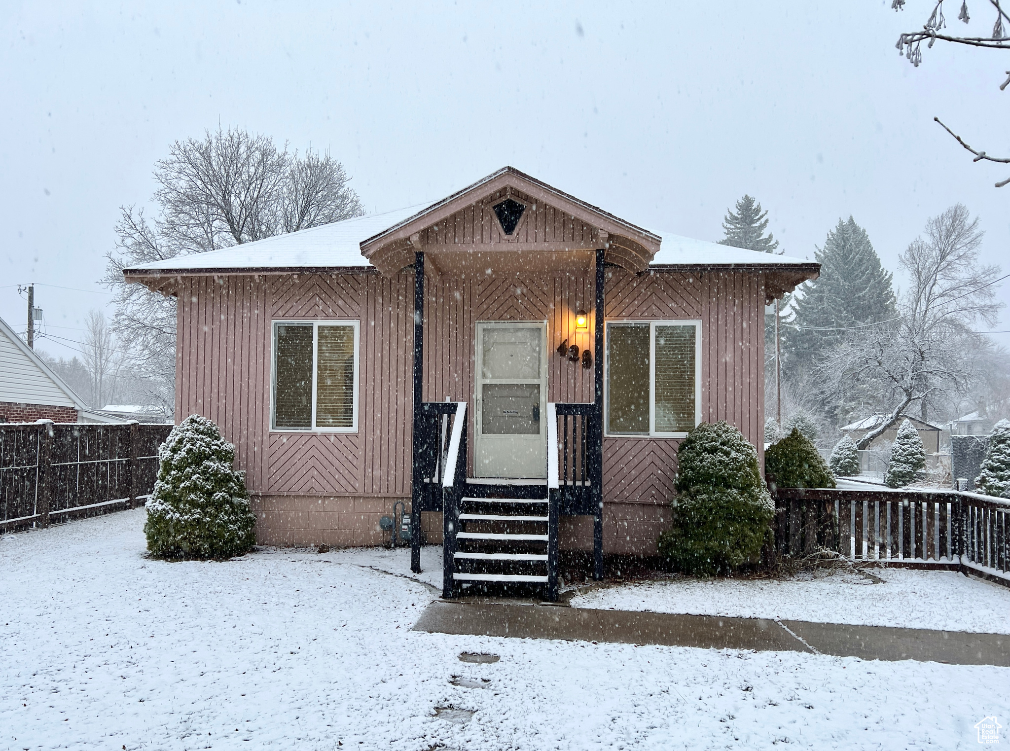 Bungalow-style home with fence