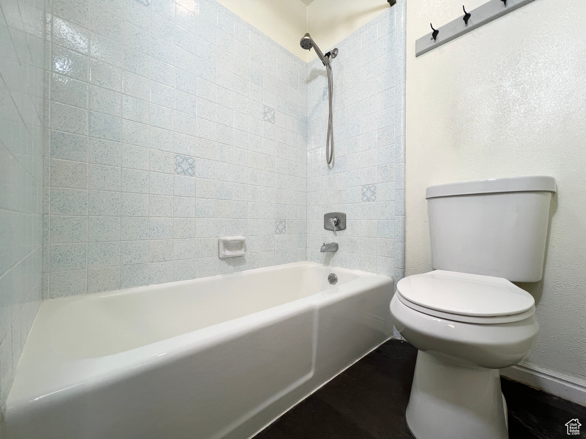 Full bath featuring toilet and shower / bathtub combination