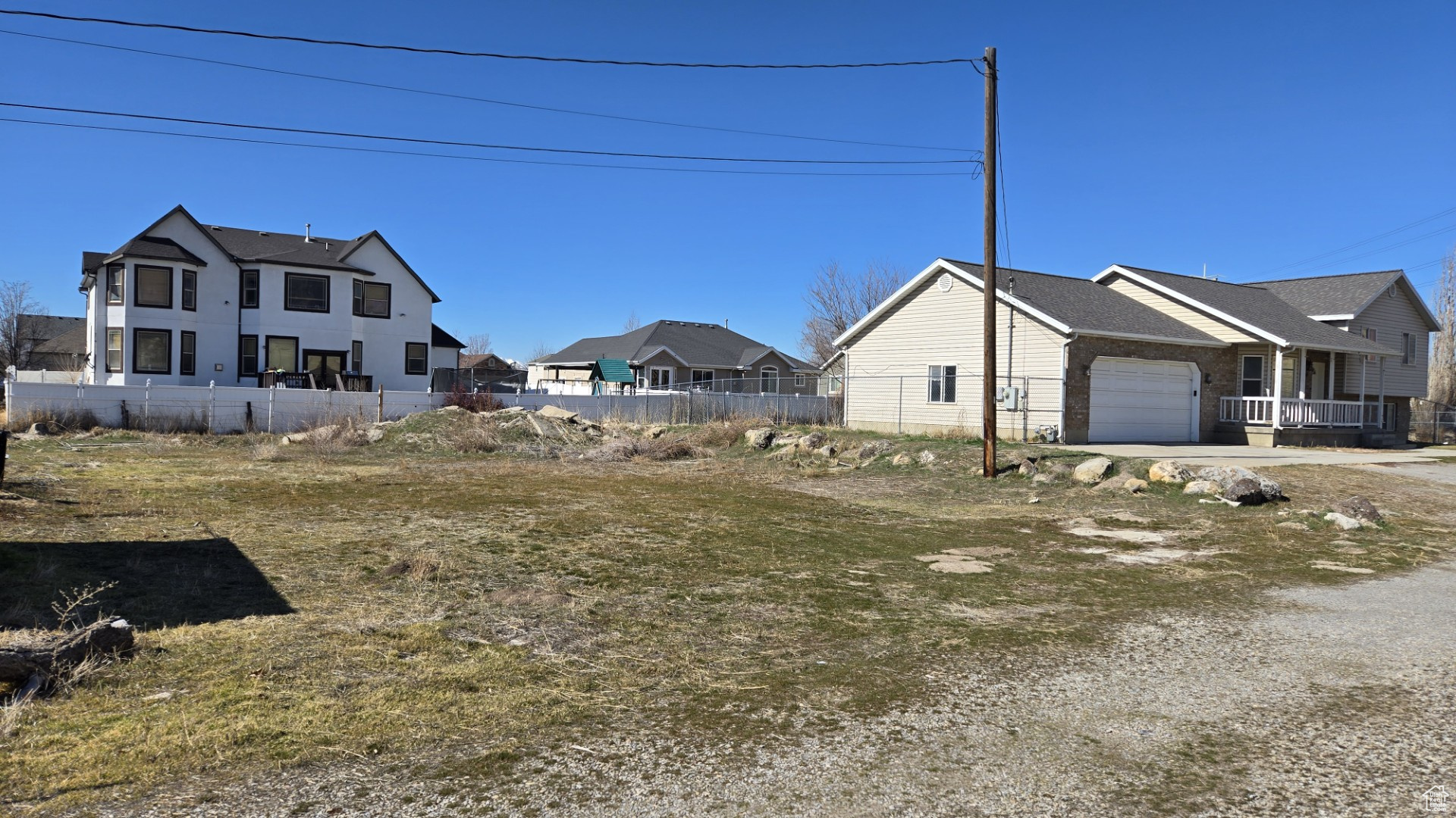 View of home's exterior with an attached garage and fence