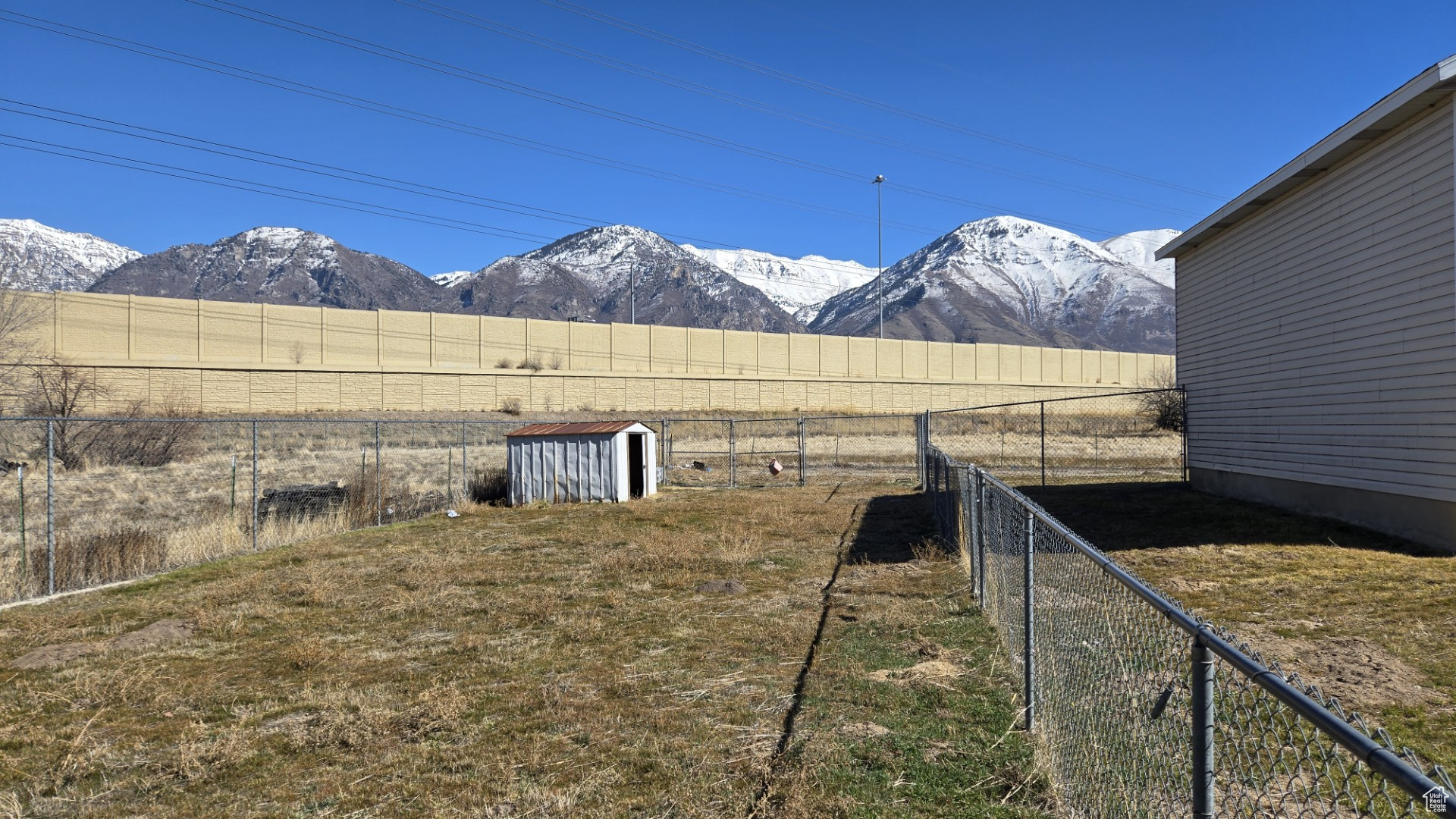 View of yard featuring a rural view, a fenced backyard, and a mountain view