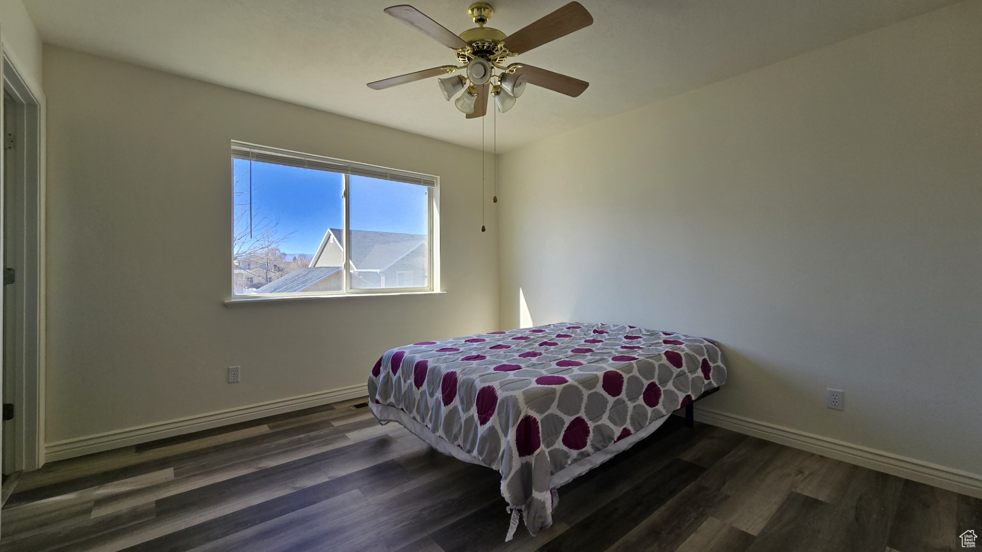 Bedroom with a ceiling fan, baseboards, and wood finished floors