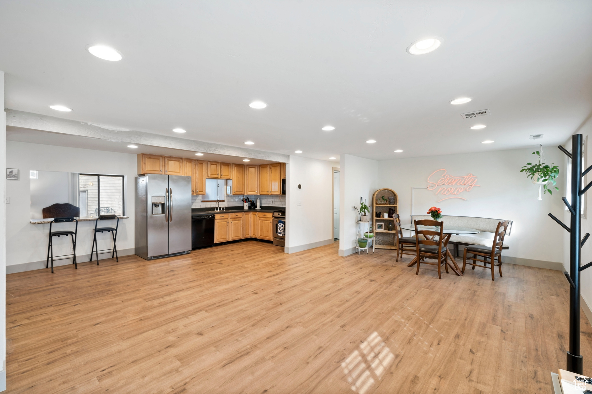 Kitchen with recessed lighting, light wood-style floors, appliances with stainless steel finishes, and dark countertops