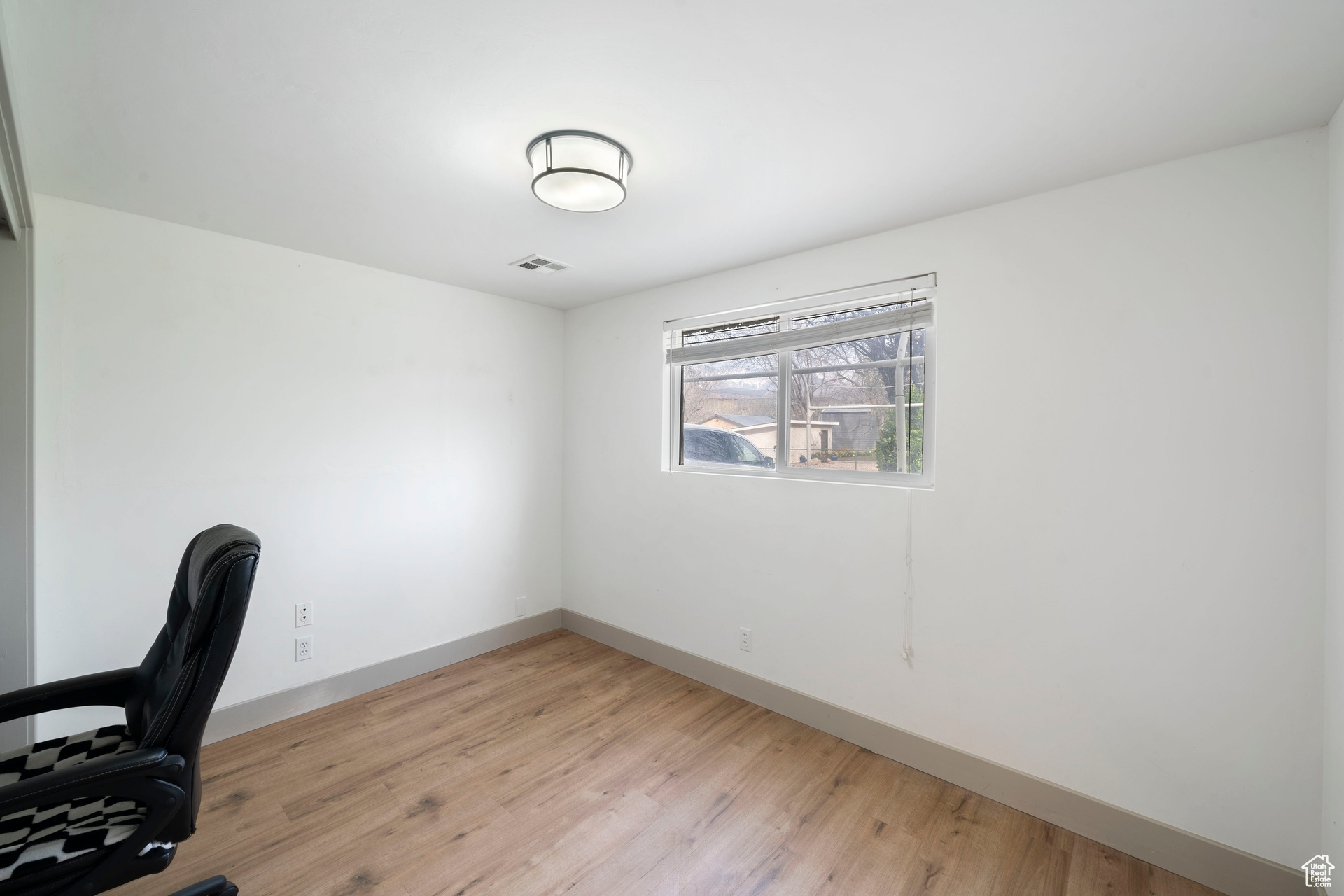 Unfurnished office and/or bedroom featuring natural light and light wood-type flooring