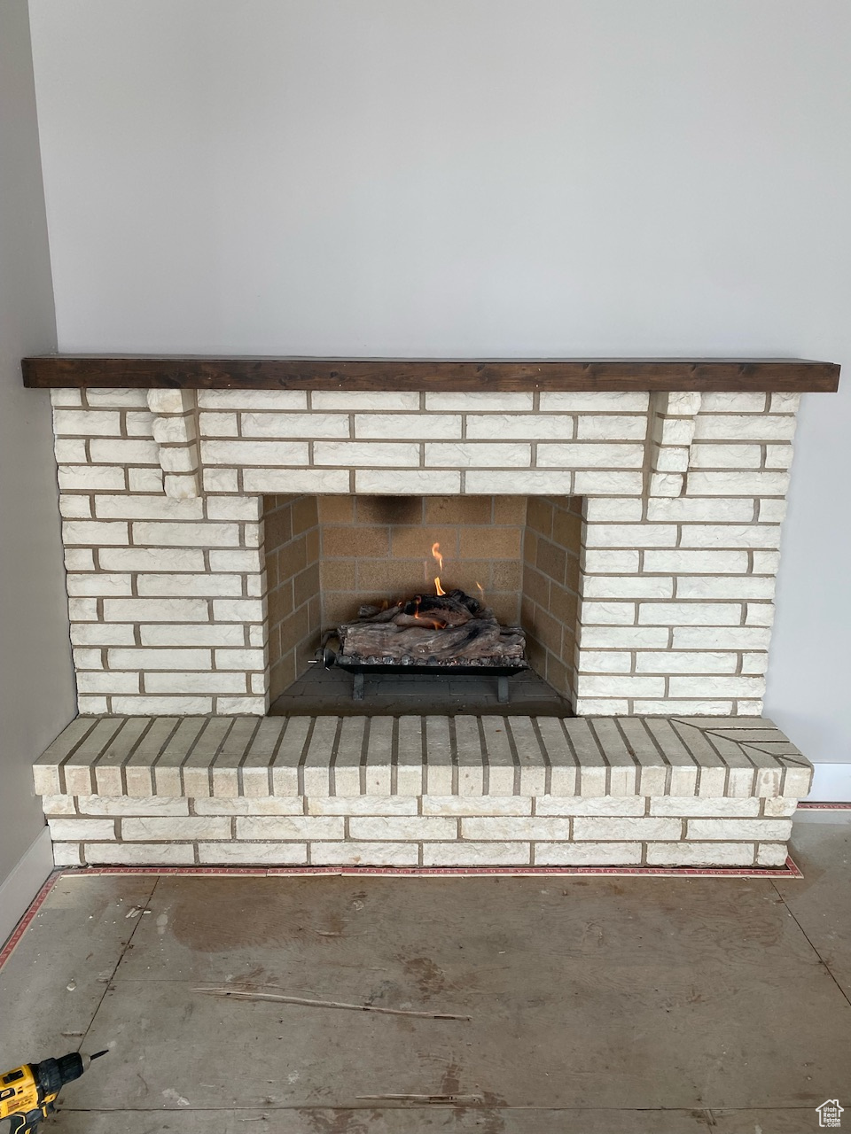 Room details featuring a brick fireplace