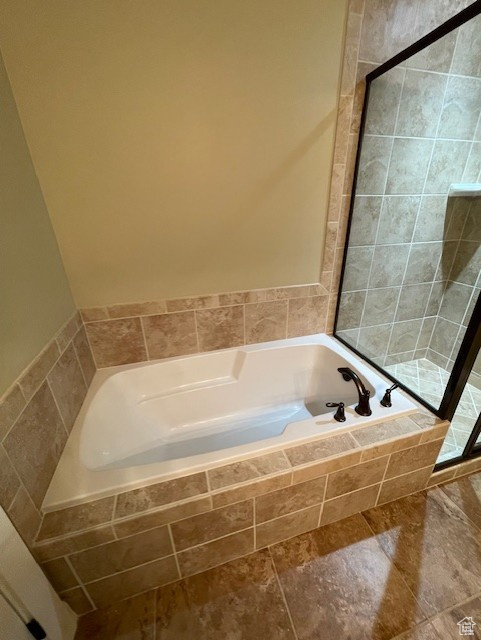 Master Bathroom with a garden tub and separate tile shower.