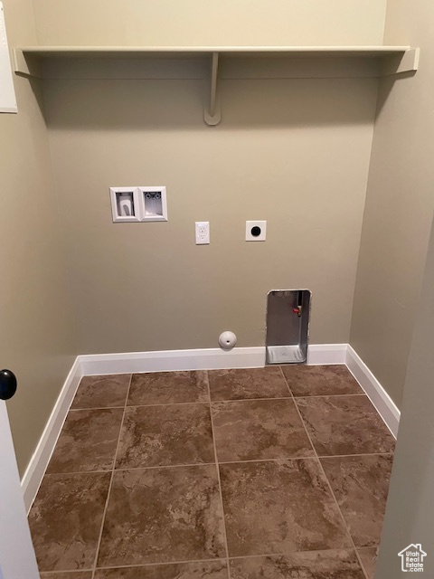 Laundry room with hookup for a washing machine, gas or electric dryer hookup, storage shelves not shown.