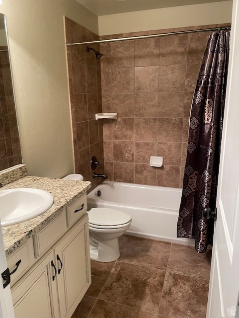 Bathroom featuring shower/bath combo with curtain. single sink vanity.