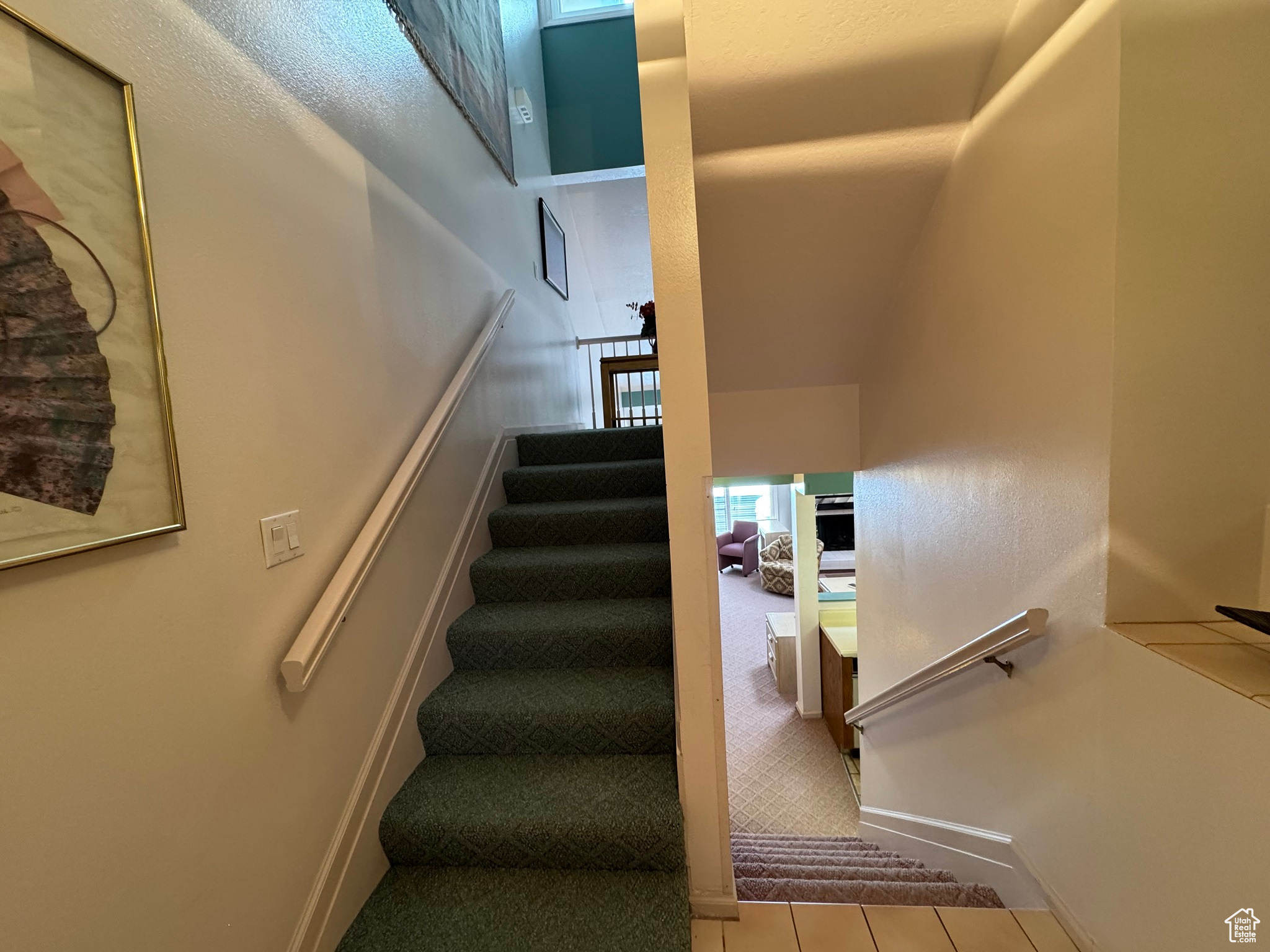 Stairway featuring tile patterned floors