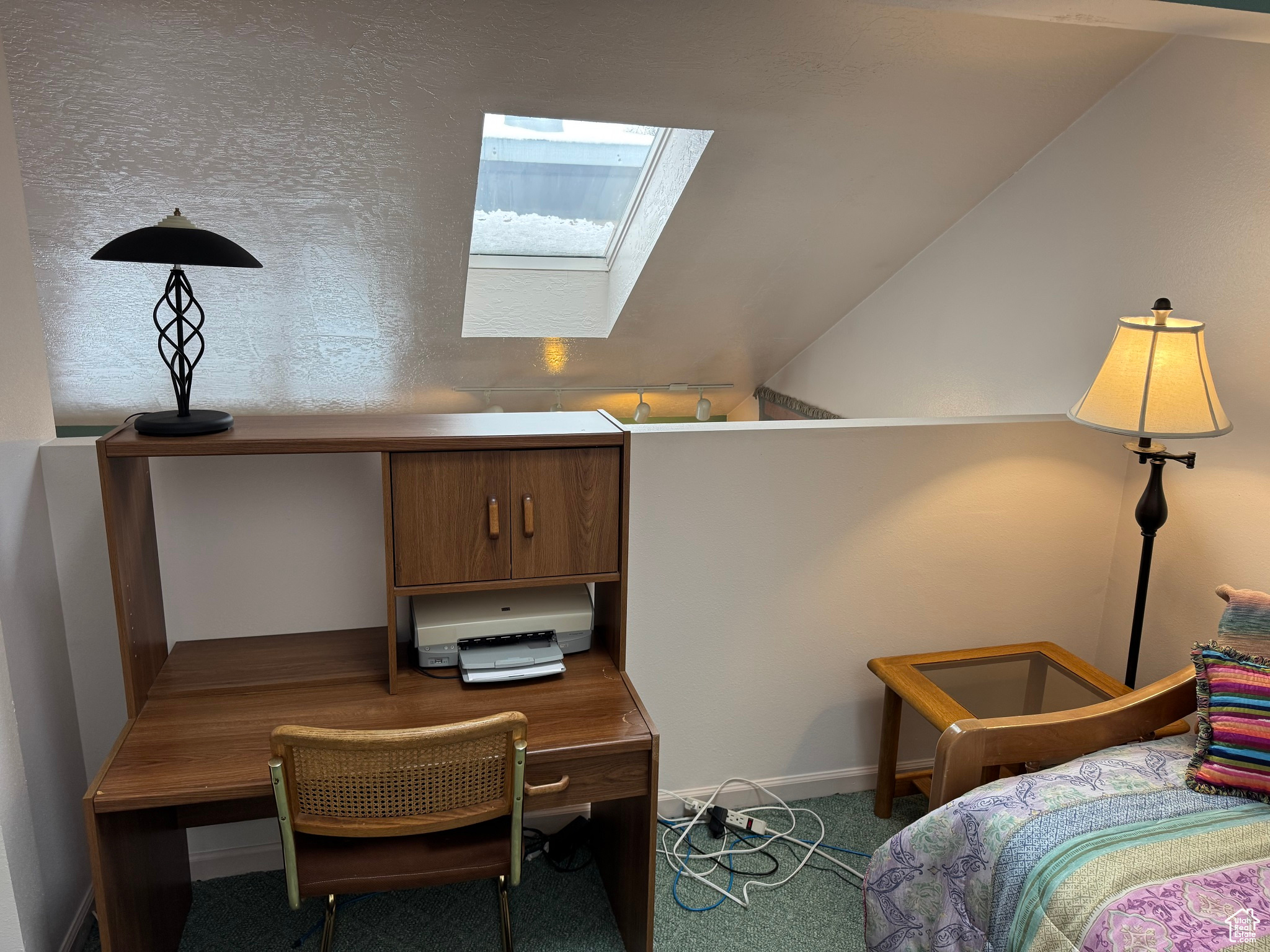 Bedroom with lofted ceiling with skylight and carpet floors