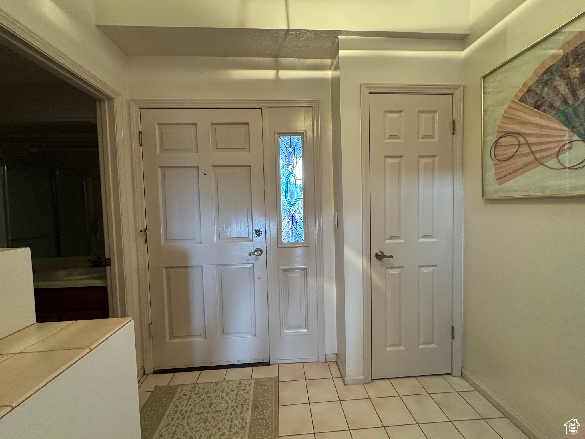 Entrance foyer featuring light tile patterned floors and baseboards