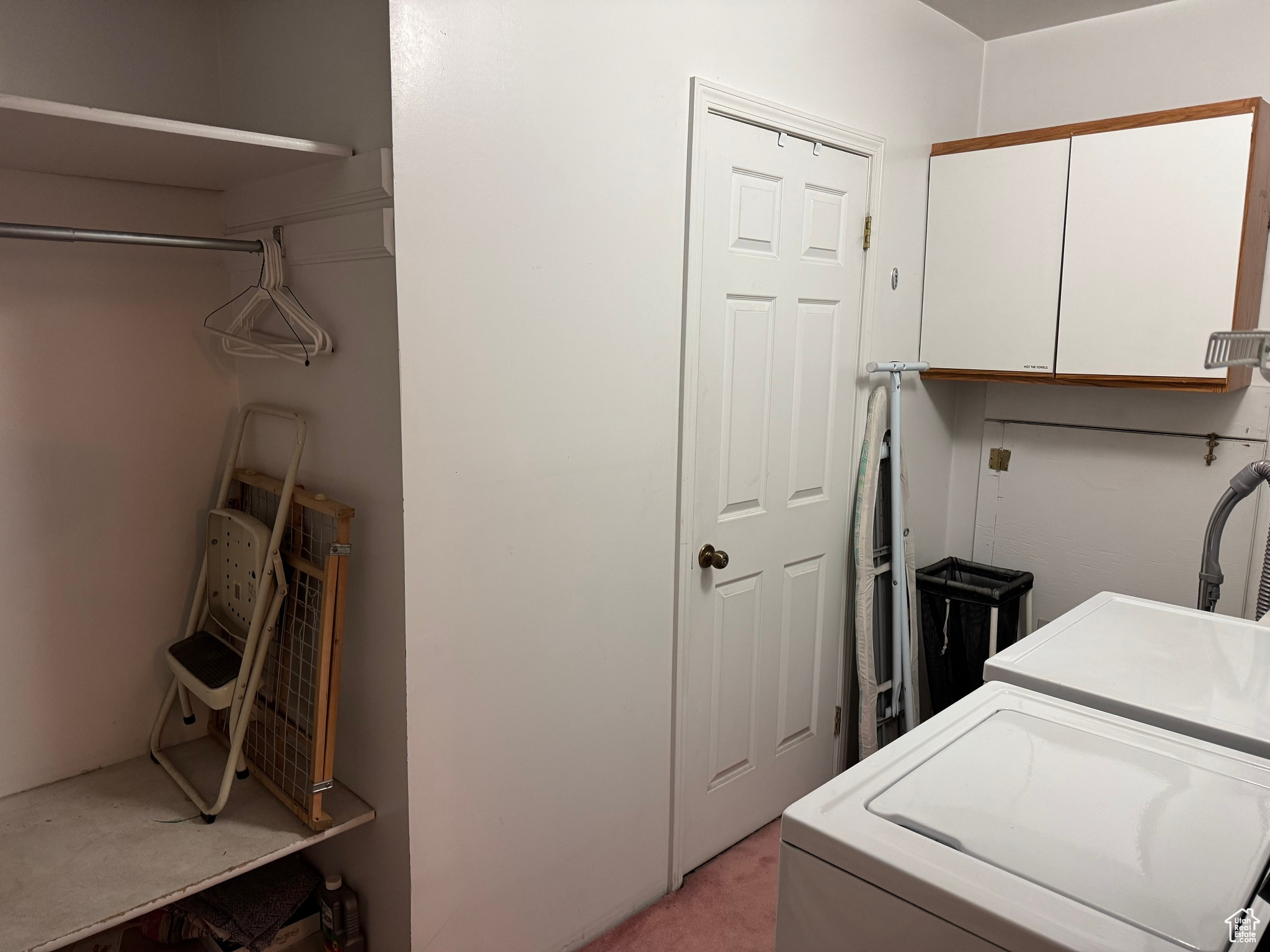 Laundry area featuring washer and dryer and cabinet space