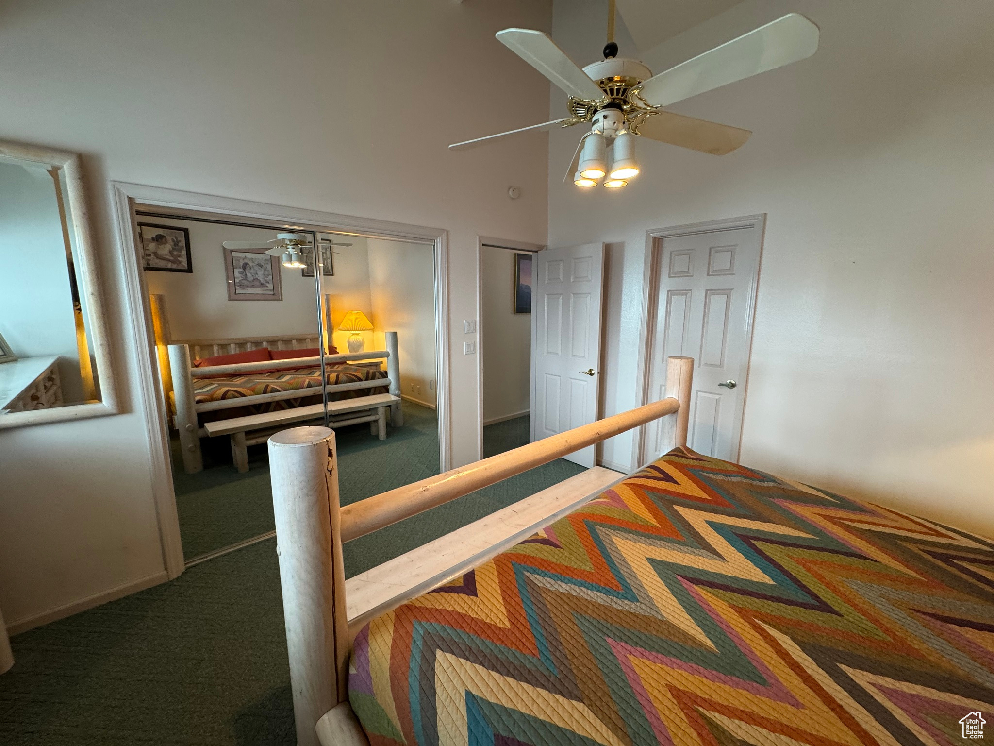 Bedroom with a high ceiling, carpet flooring, and ceiling fan