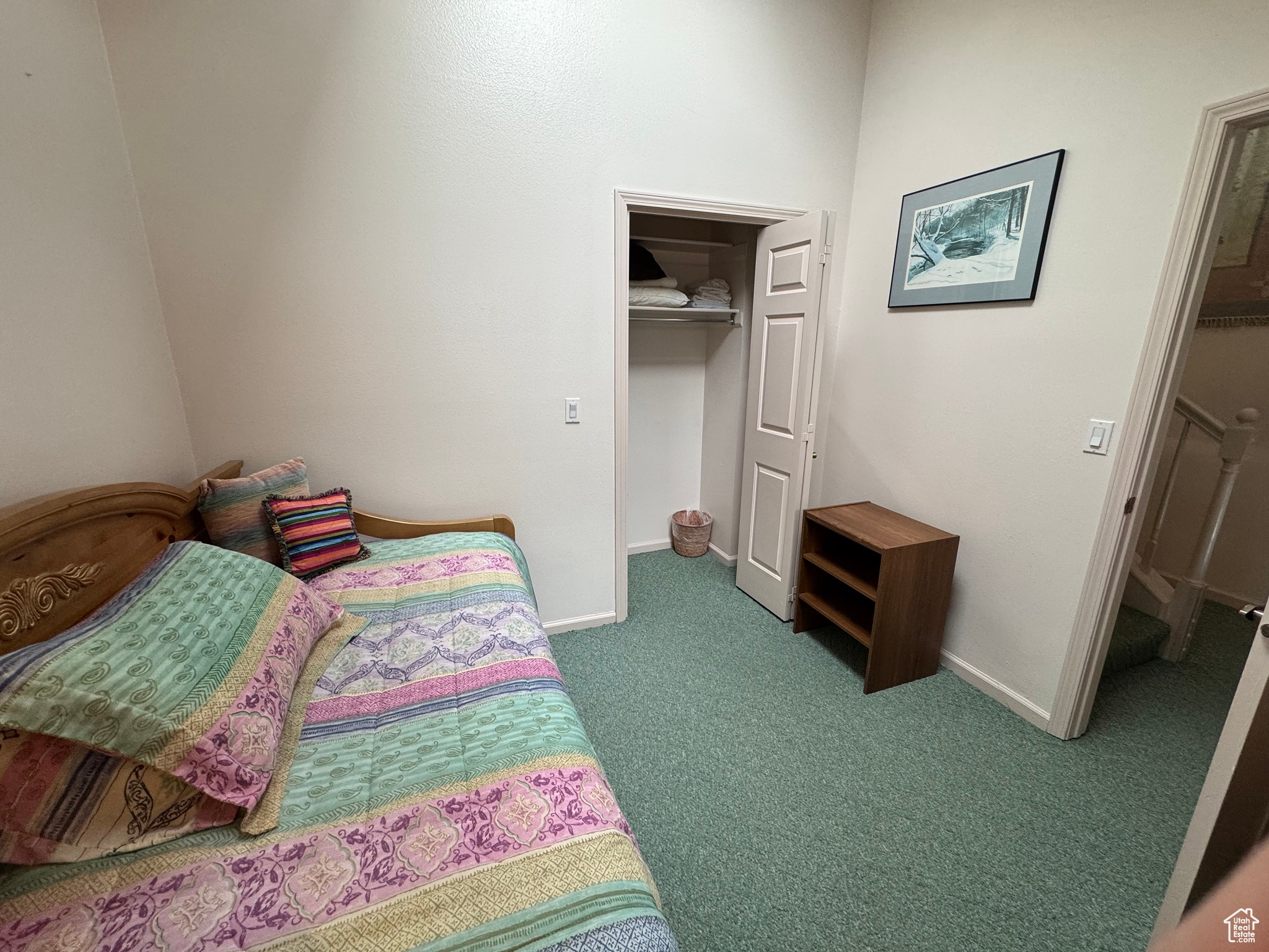 Bedroom featuring a spacious closet, carpet flooring, baseboards, and a closet