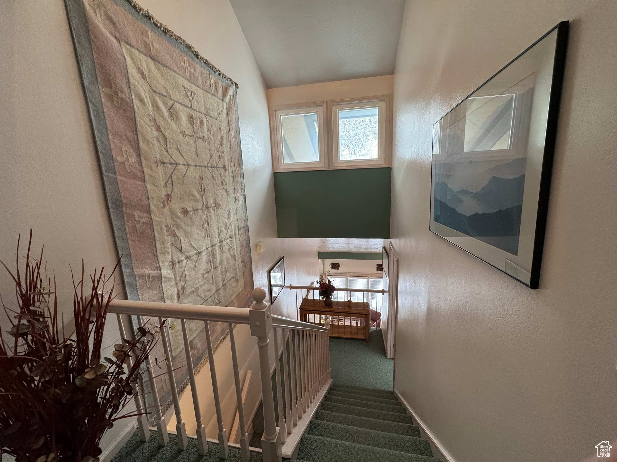 Stairs with lofted ceiling and carpet