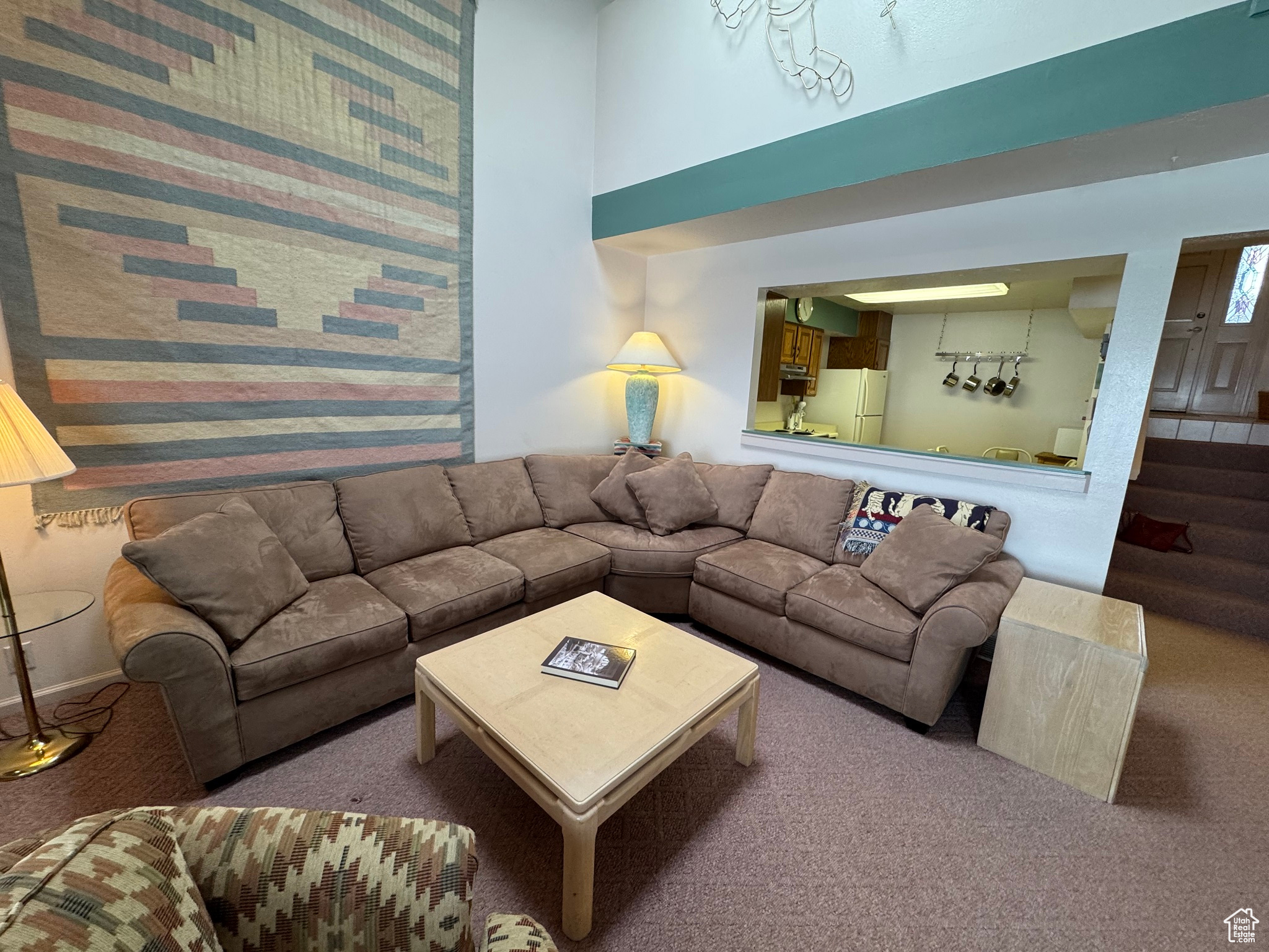 Living area featuring carpet floors and a high ceiling